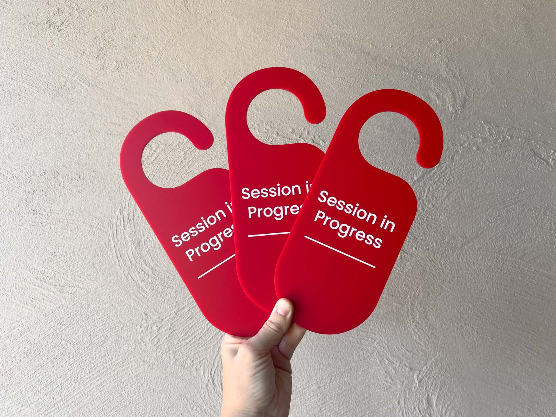 Three custom printed red 'Session in Progress' signs held against a light gray wall | Coji Designs
