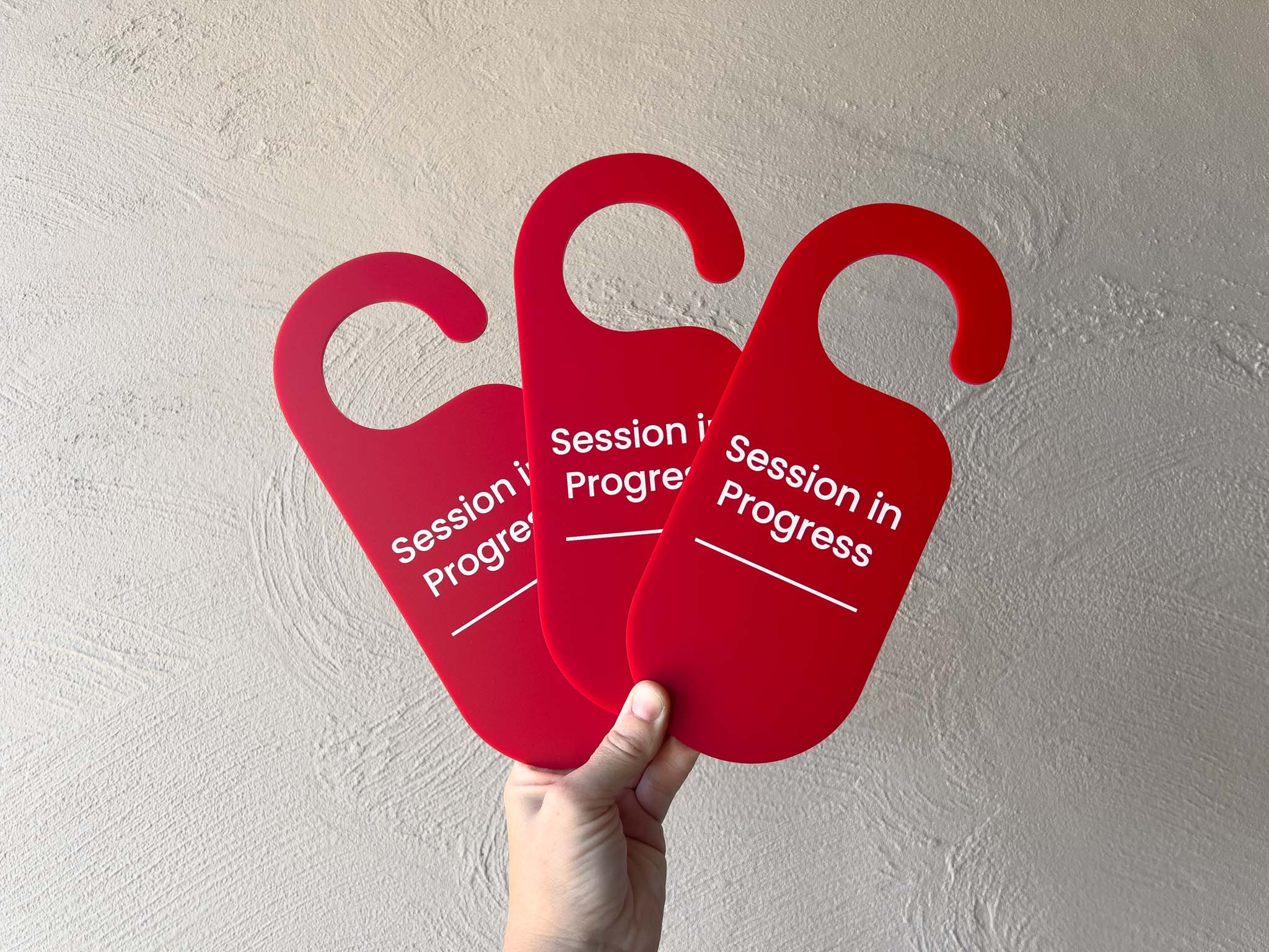 Three custom printed red 'Session in Progress' signs held against a light gray wall | Coji Designs
