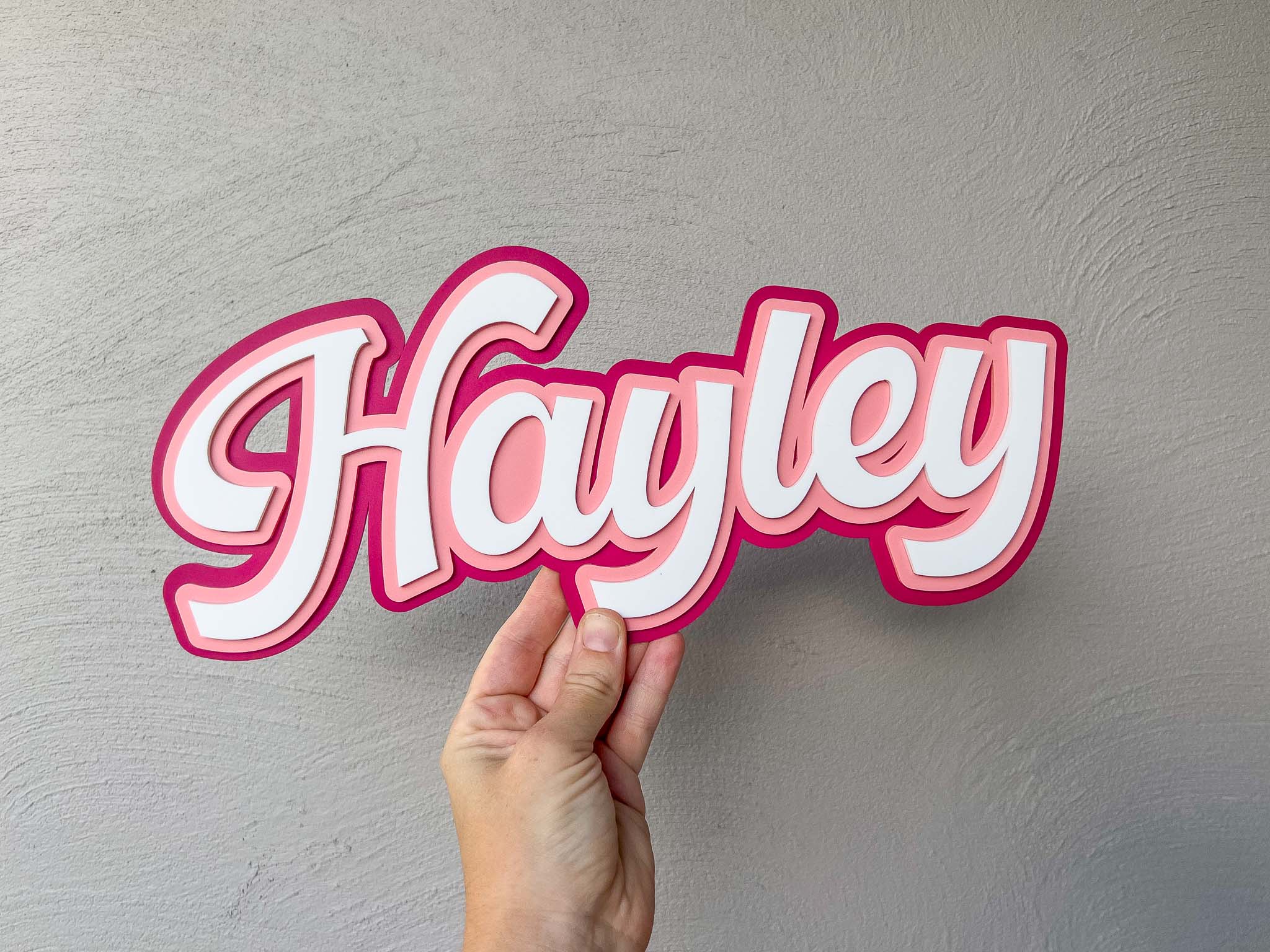 Soda shop style handmade custom acrylic name sign 'Hayley' in pink, melon and white.