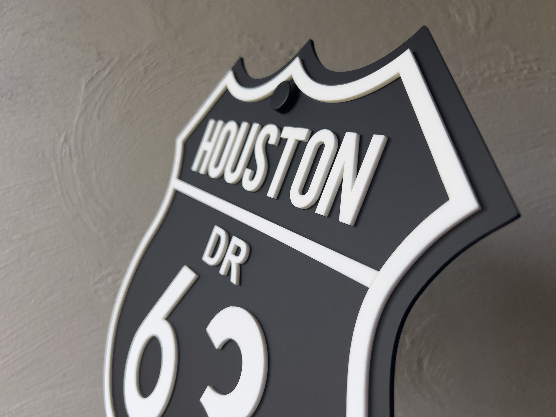 Decorative sign with '63 Houston DR' text on a textured wall | Coji Designs