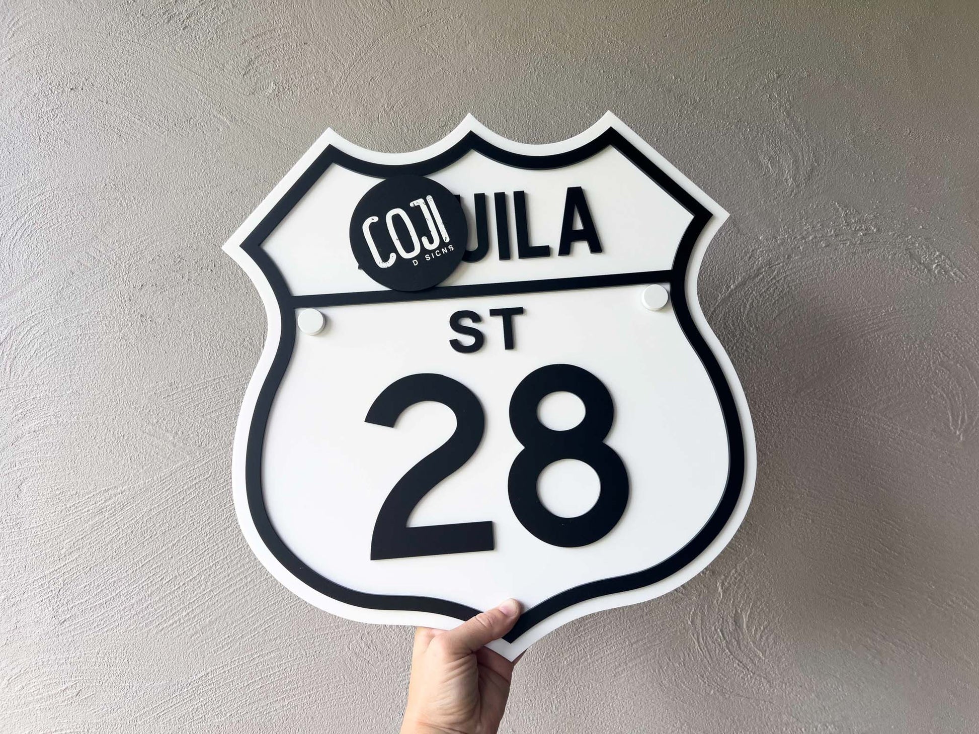 Decorative sign with '28 Cohuila St' text on a plain background | Coji Designs