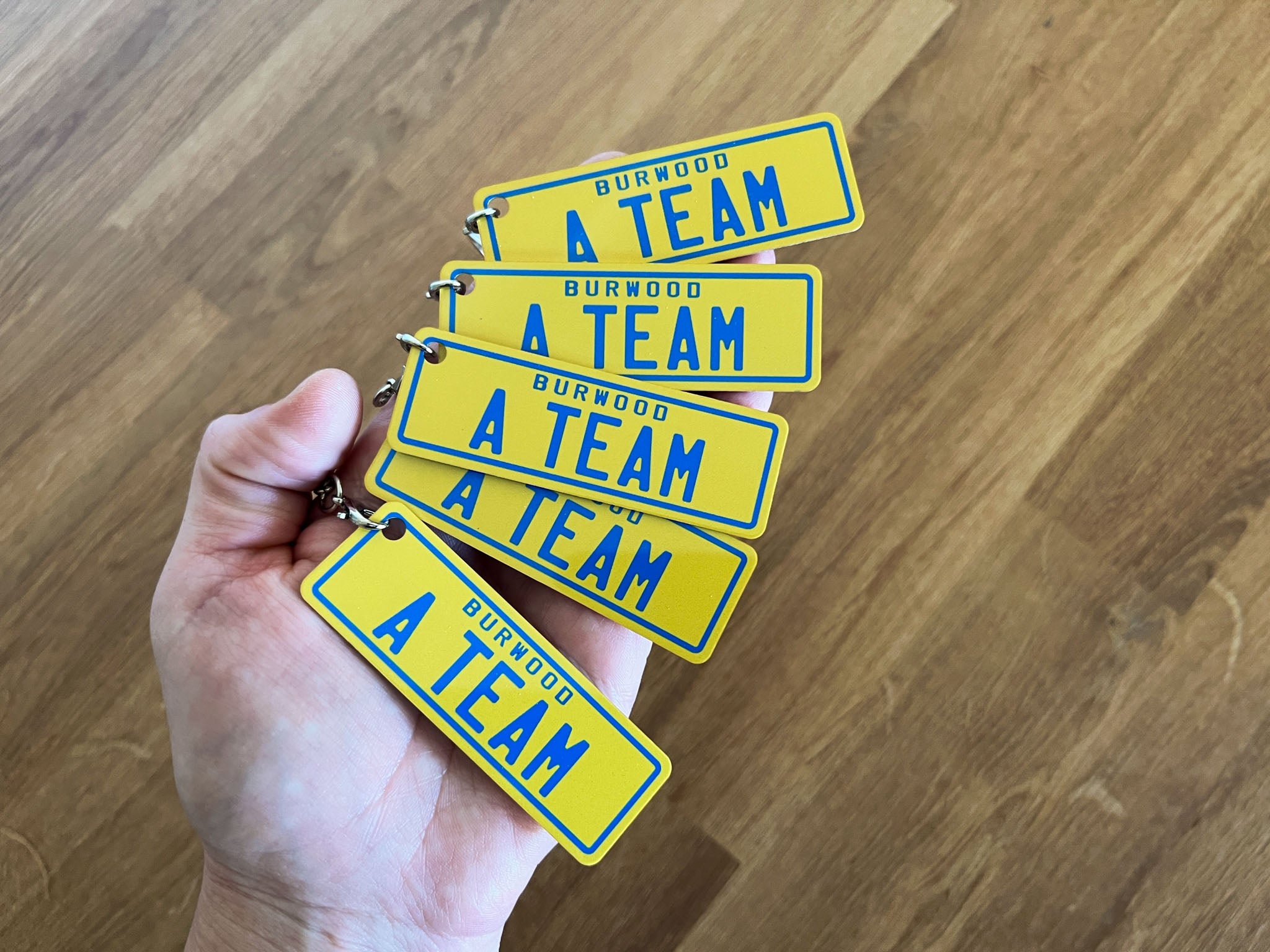 Cool fun team bonding custom printed number plate style keychain that says 'Burwood A-Team'.