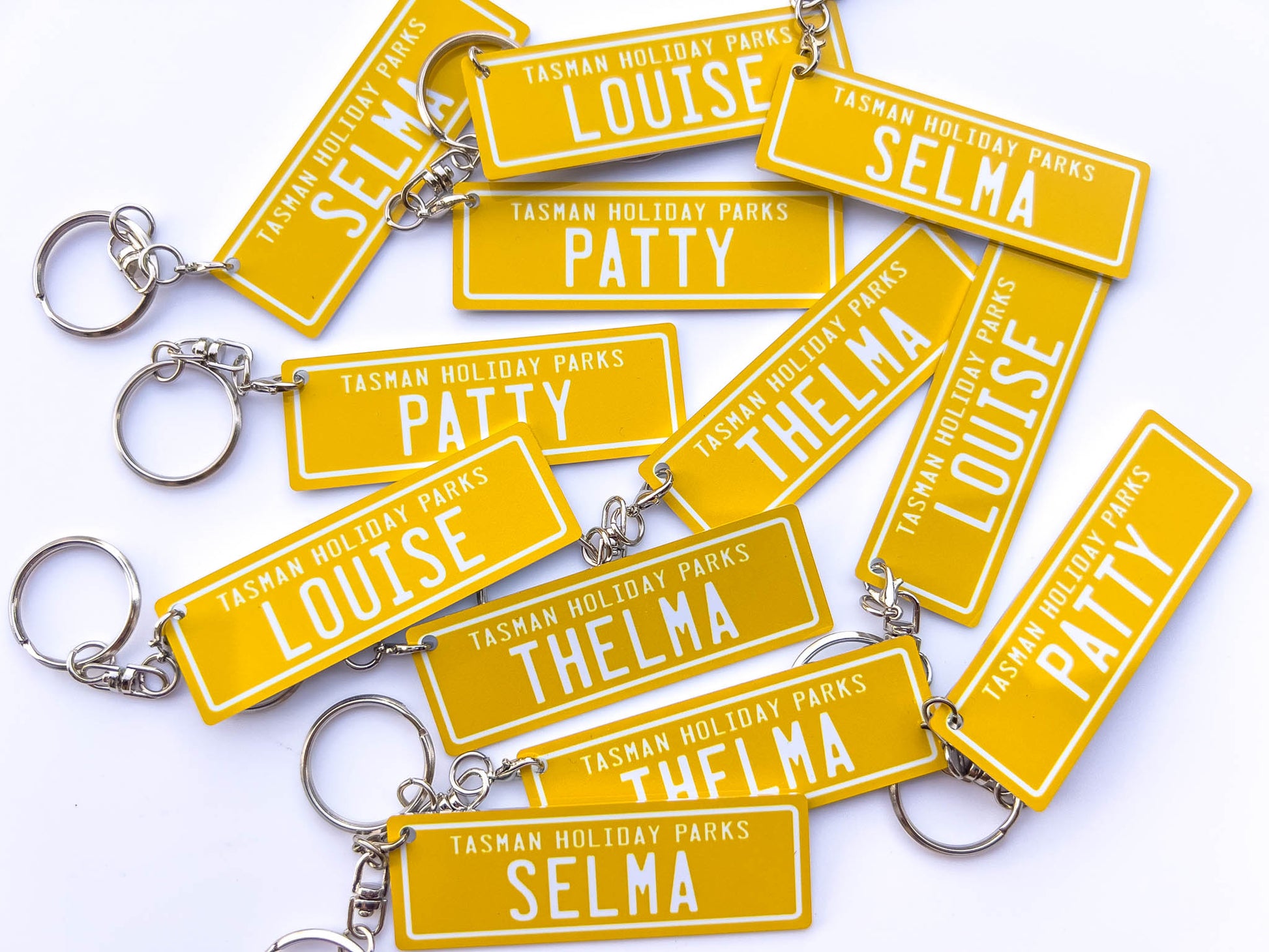 Golden yellow and white printed aluminium keychains with fun names