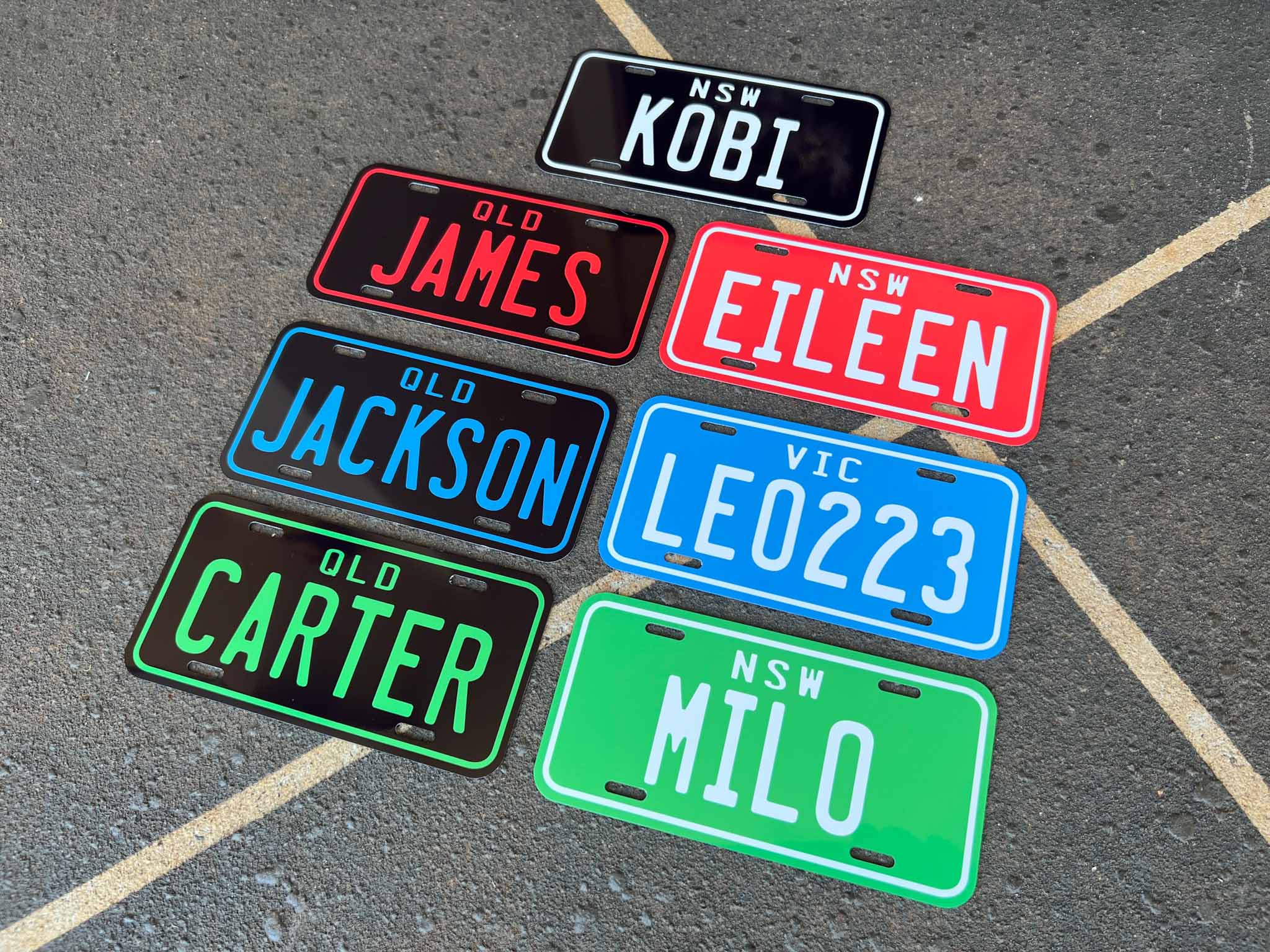 Collection of personalised kids mini plates on a textured surface