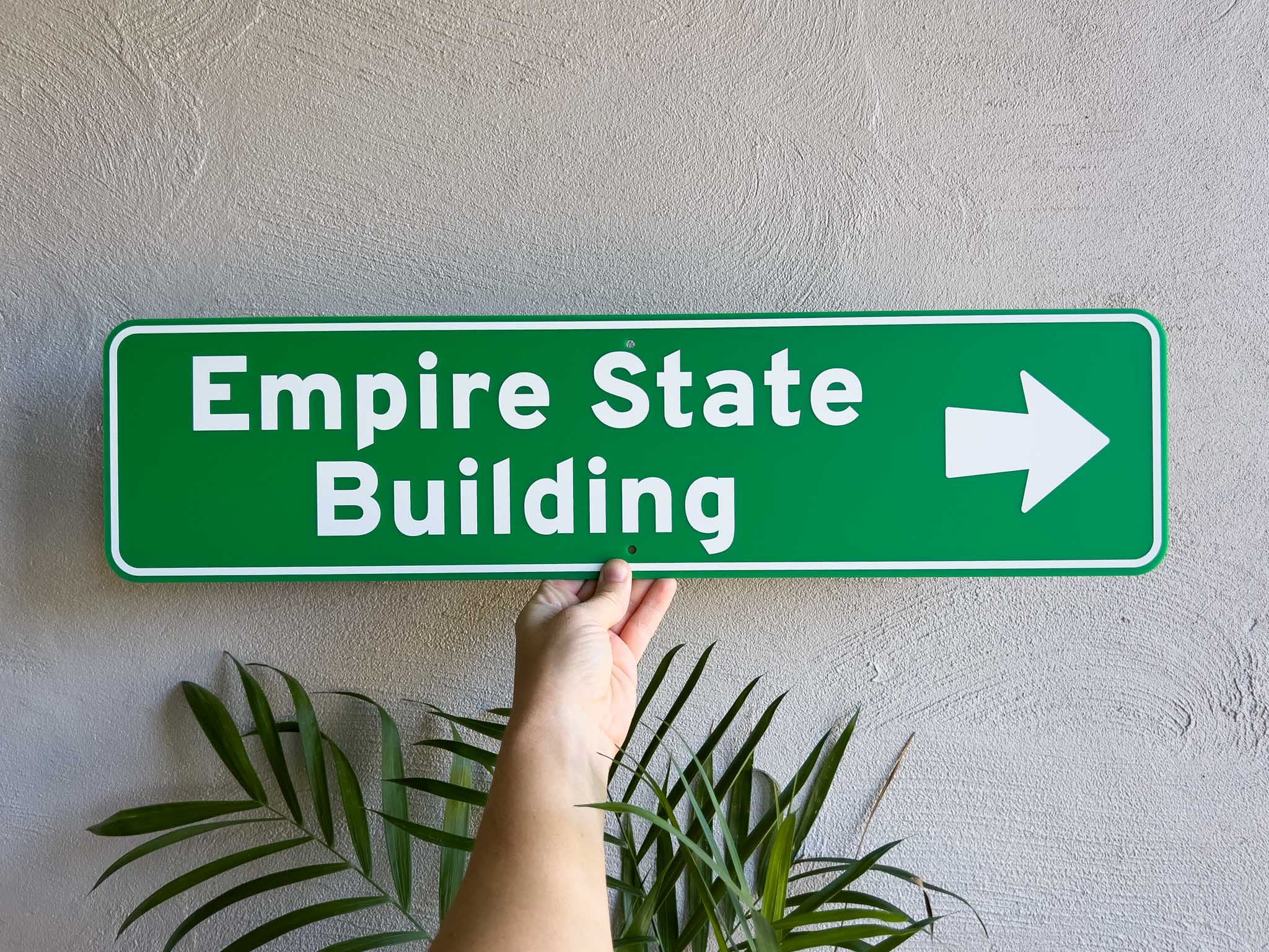 Custom novelty highway street sign that says 'Empire State Building' in a forest green colour.
