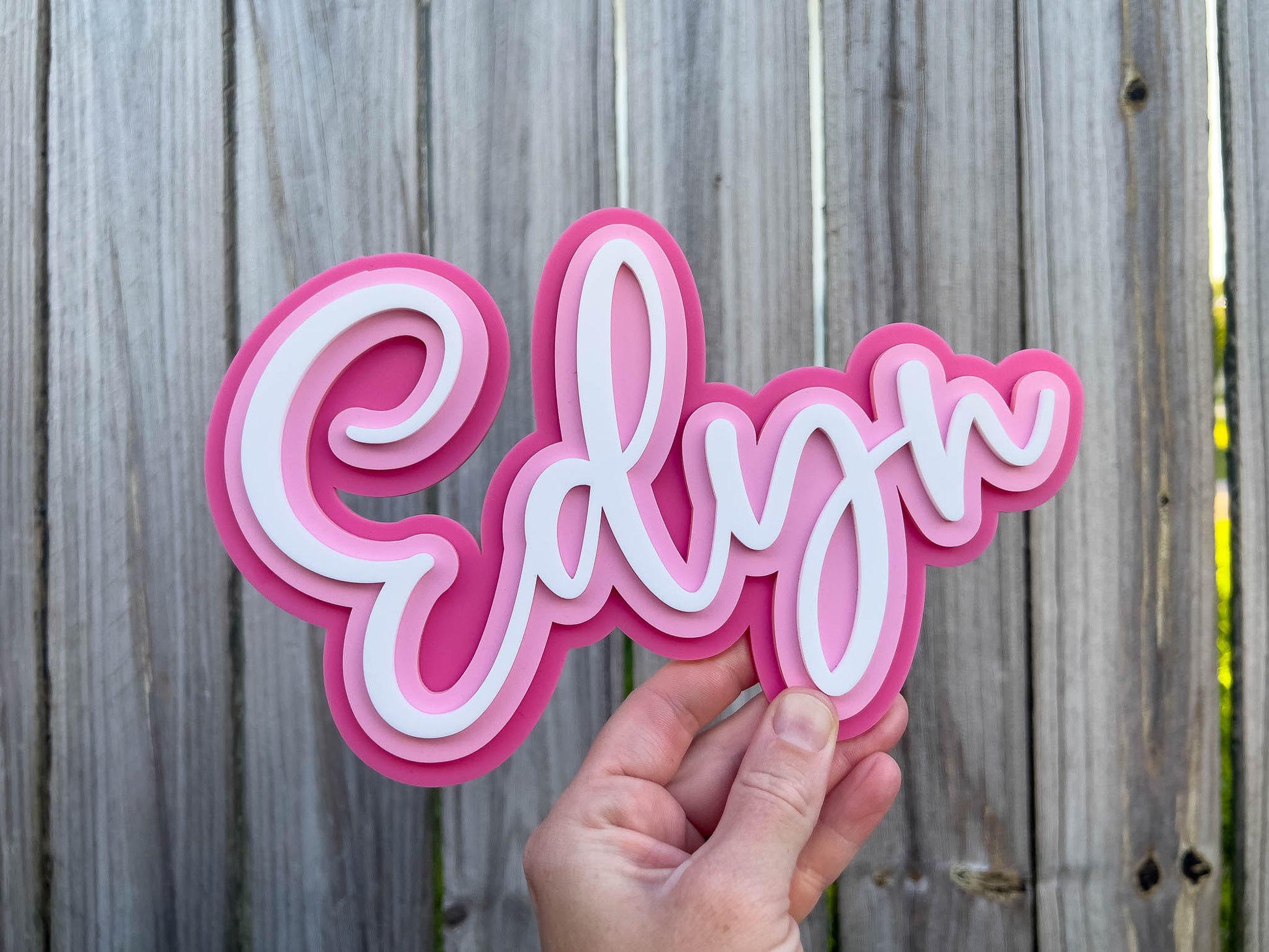 Cute pink and white mini name plaque with the name 'Edyn' laser cut in 3D layered acrylic.