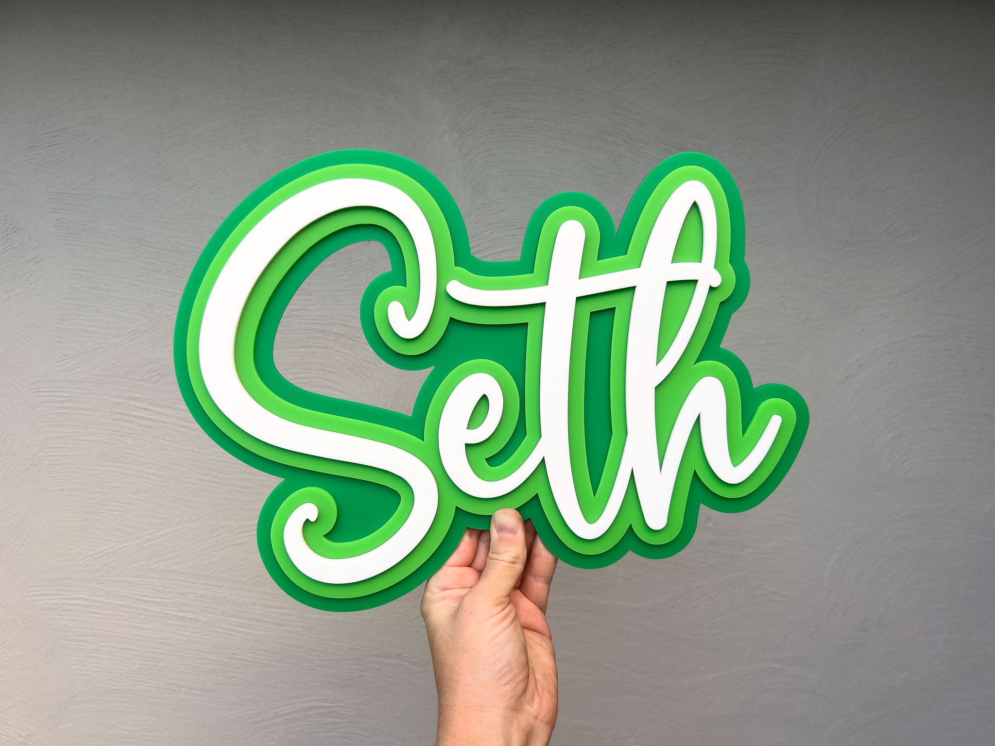 Custom 3D acrylic name plaque with'Seth' in vibrant green and white.