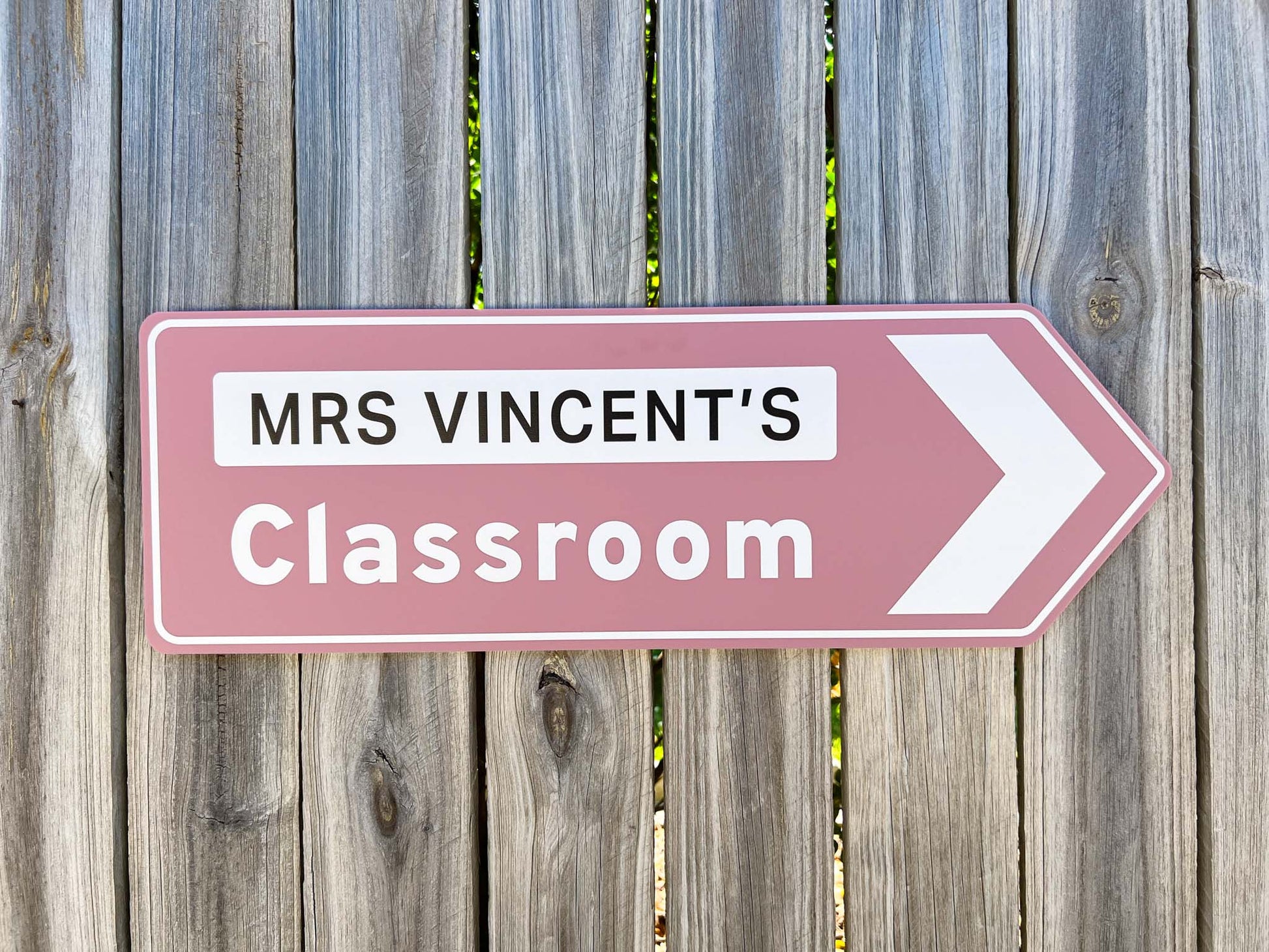 A classic style highway sign in a dusty pink that says 'MRS VINCENT'S Classroom'.