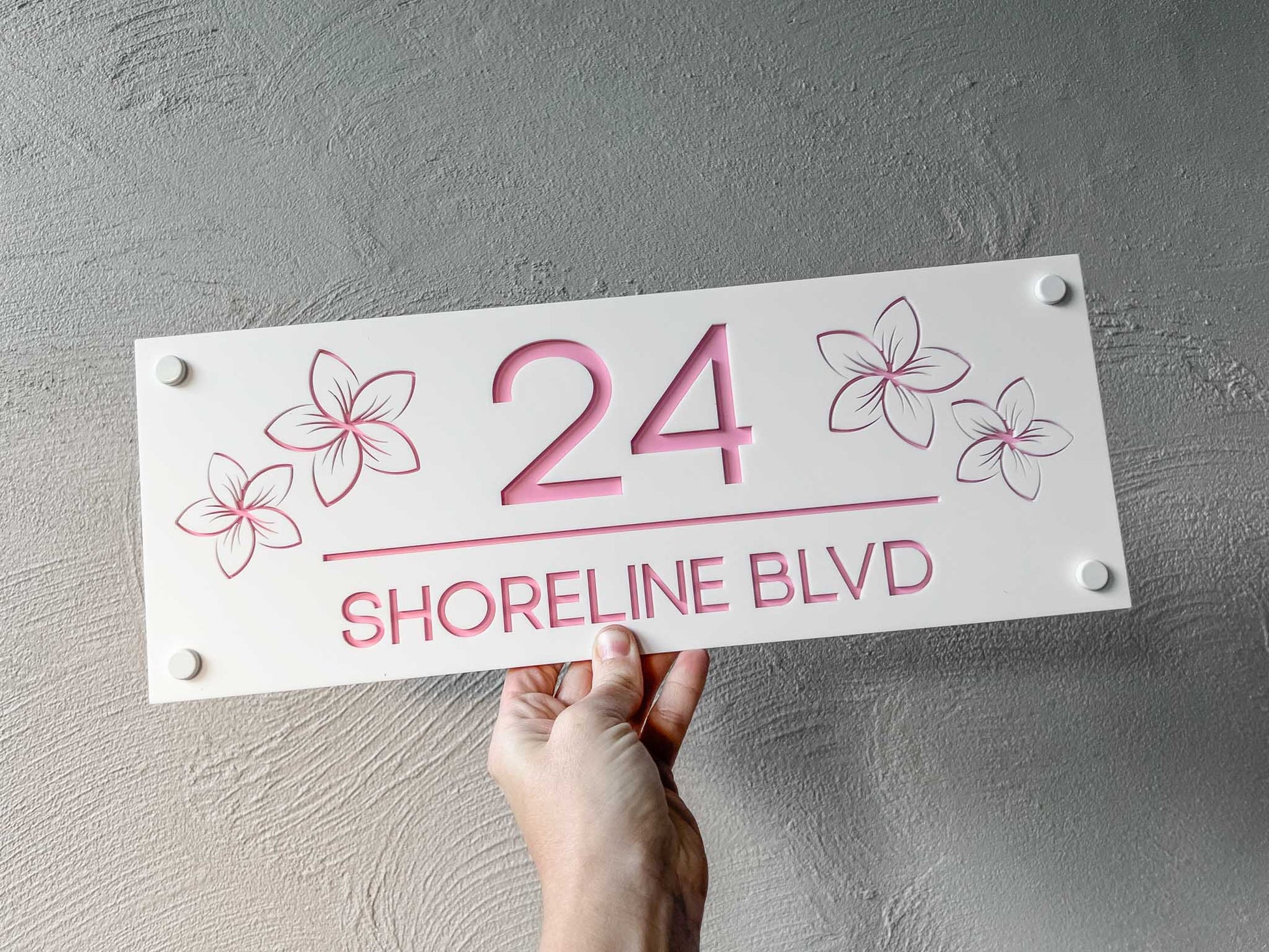 Handmade 3D acrylic white and light pink street address sign with '24 Shoreline Blvd' written on it.