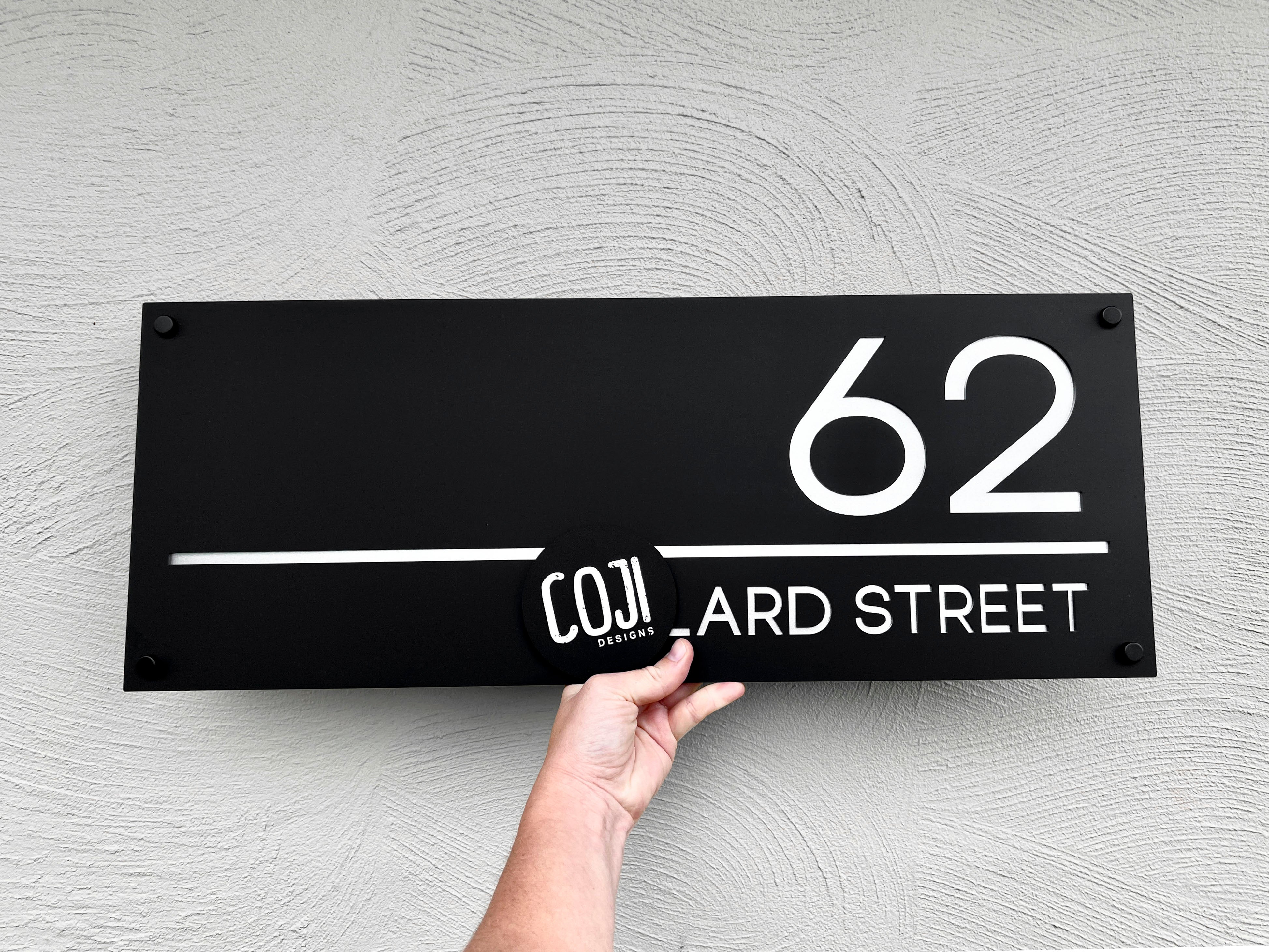 Large rectangle street address sign in black and white.