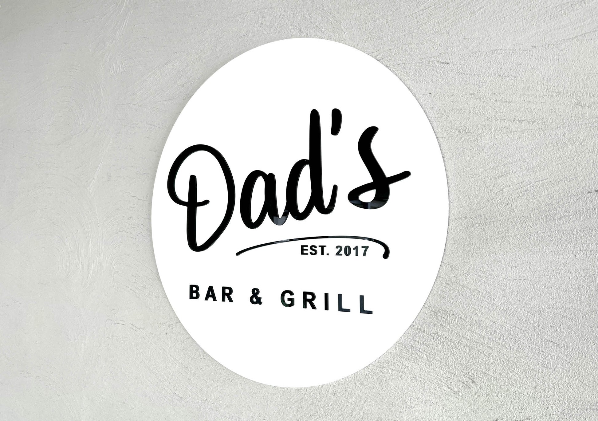 Custom round 3D acrylic sign that says 'Dads Bar & Grill' in white and black.