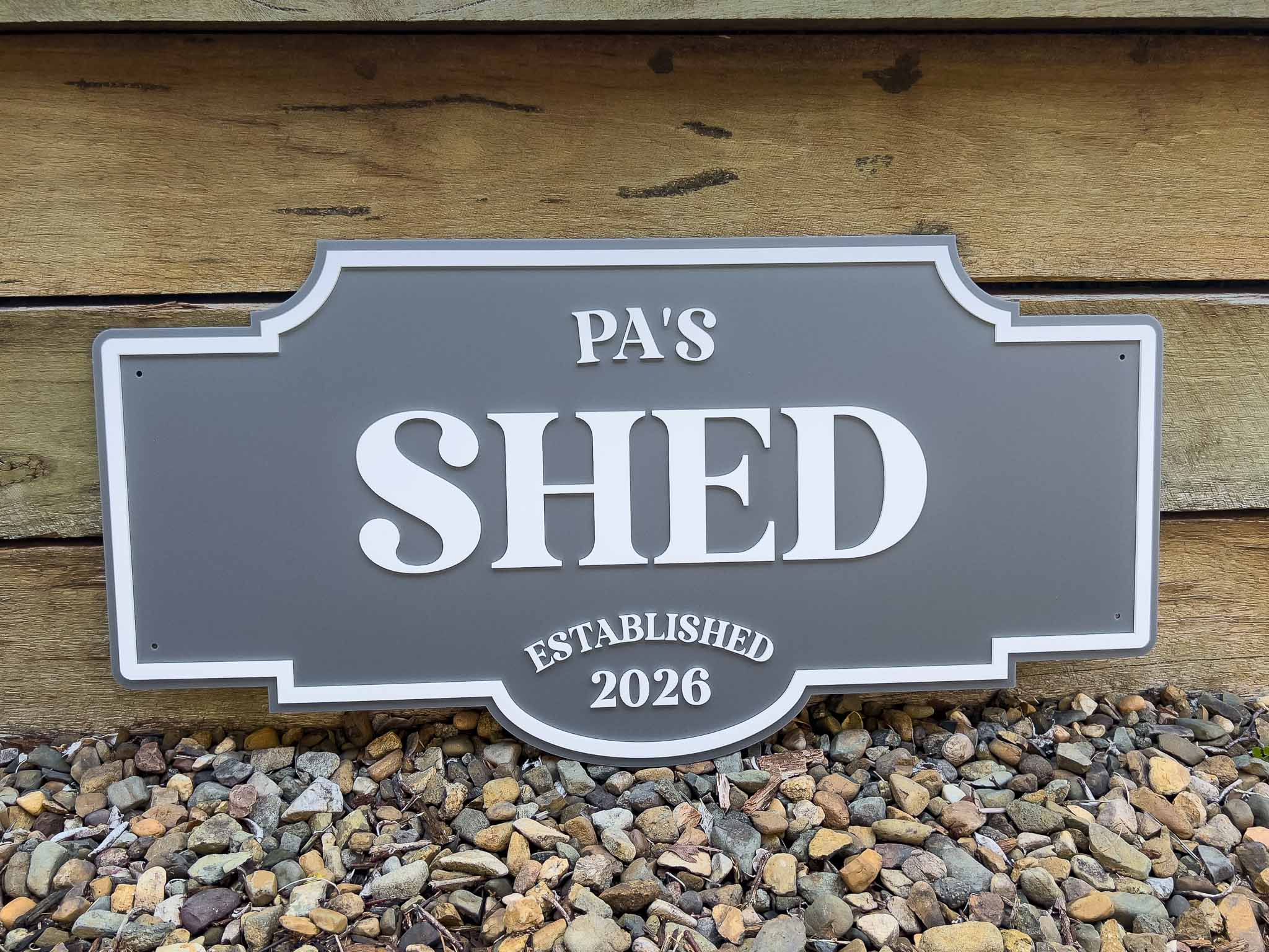 Decorative 3D acrylic sign reading 'PA'S SHED ESTABLISHED 2026' on a wooden background.