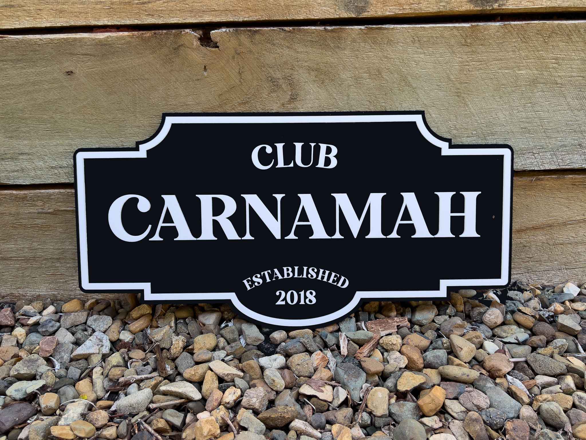 Black and white classic vintage sign with 'Club Carnamah Established 2018' text on a wooden background