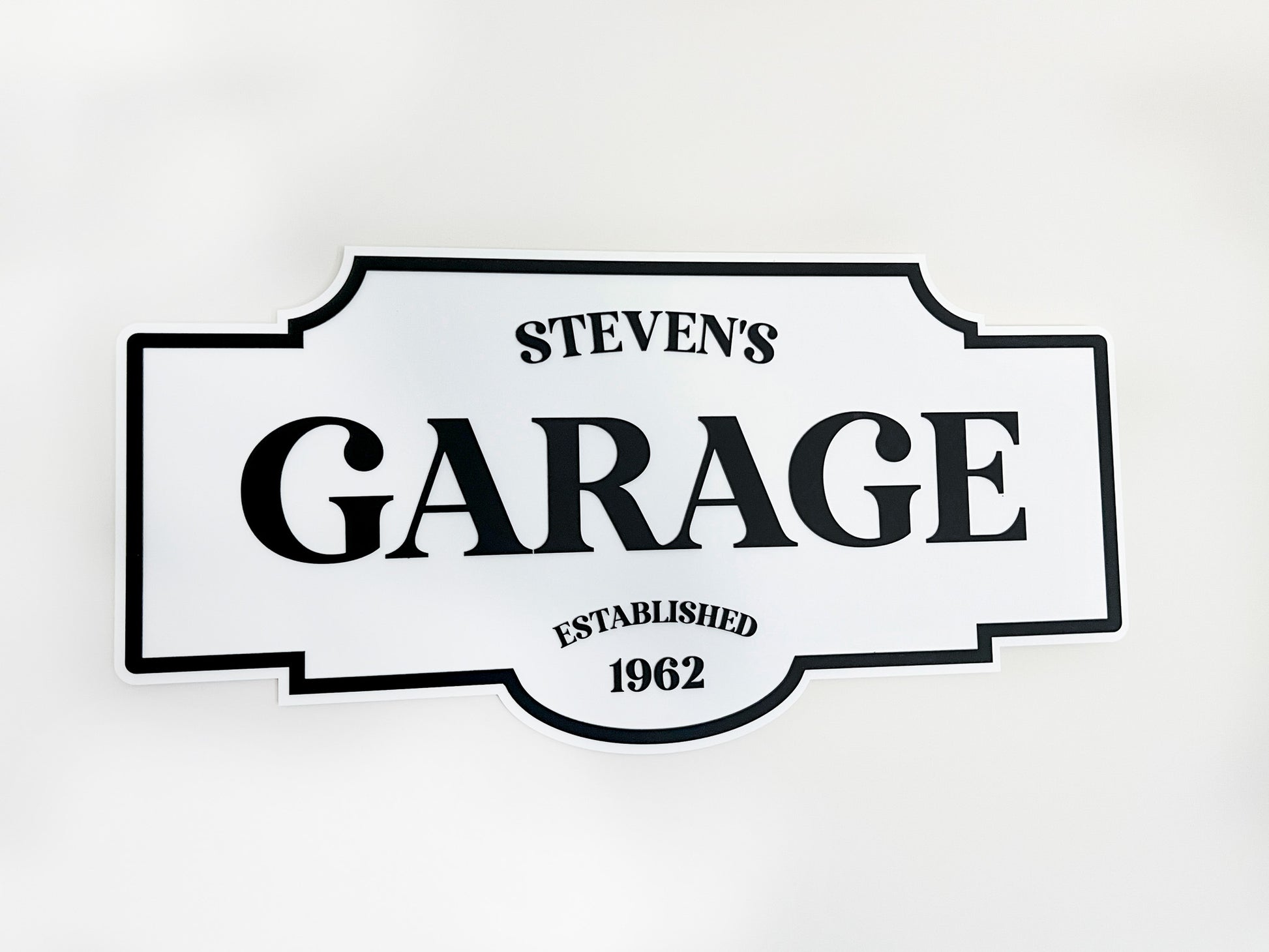 Personalised vintage garage sign with 'Steven's Garage Established 1962' text on a white background