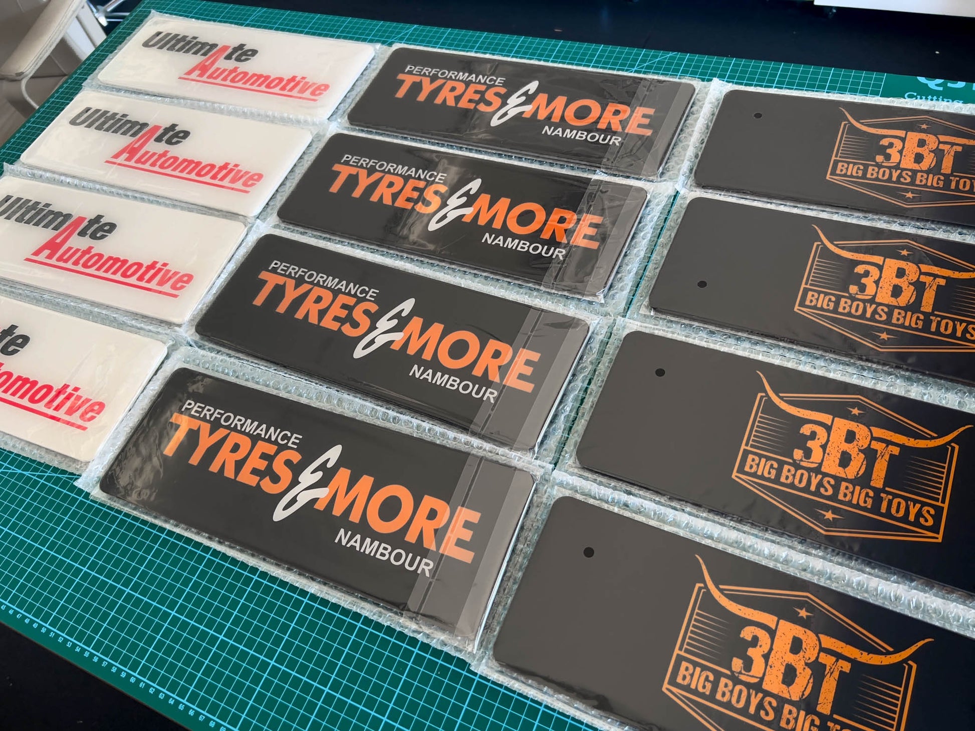 A collection of branded custom printed acrylic logo plates