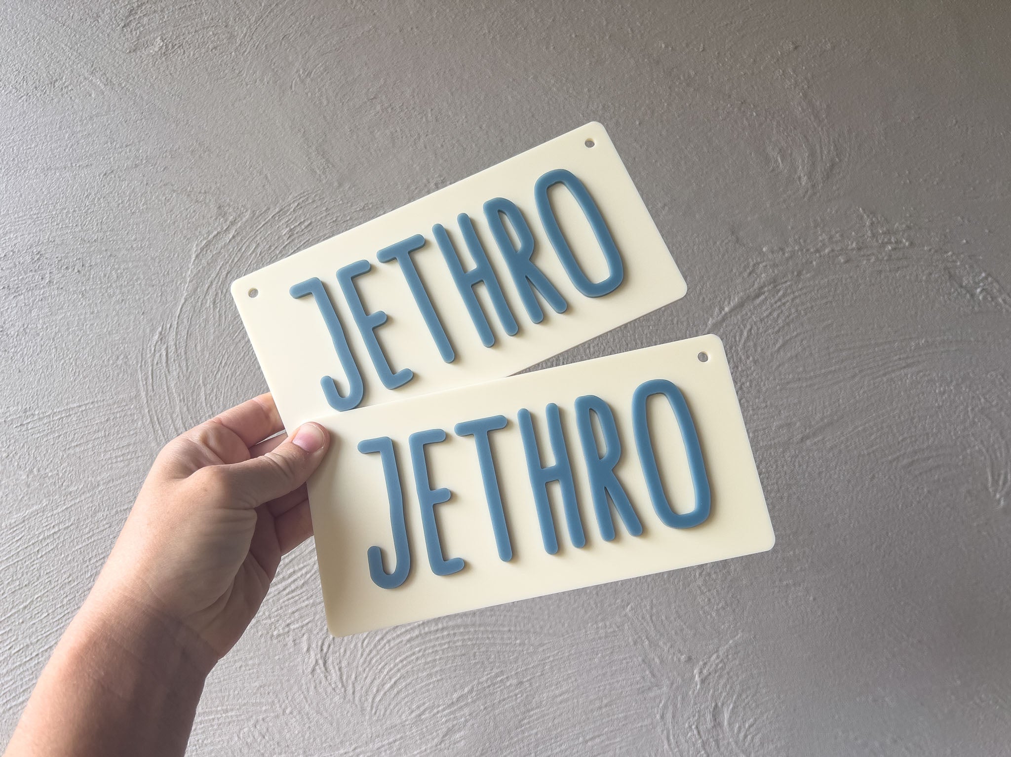 Two 'Jethro' name plates held against a gray background | Coji Designs