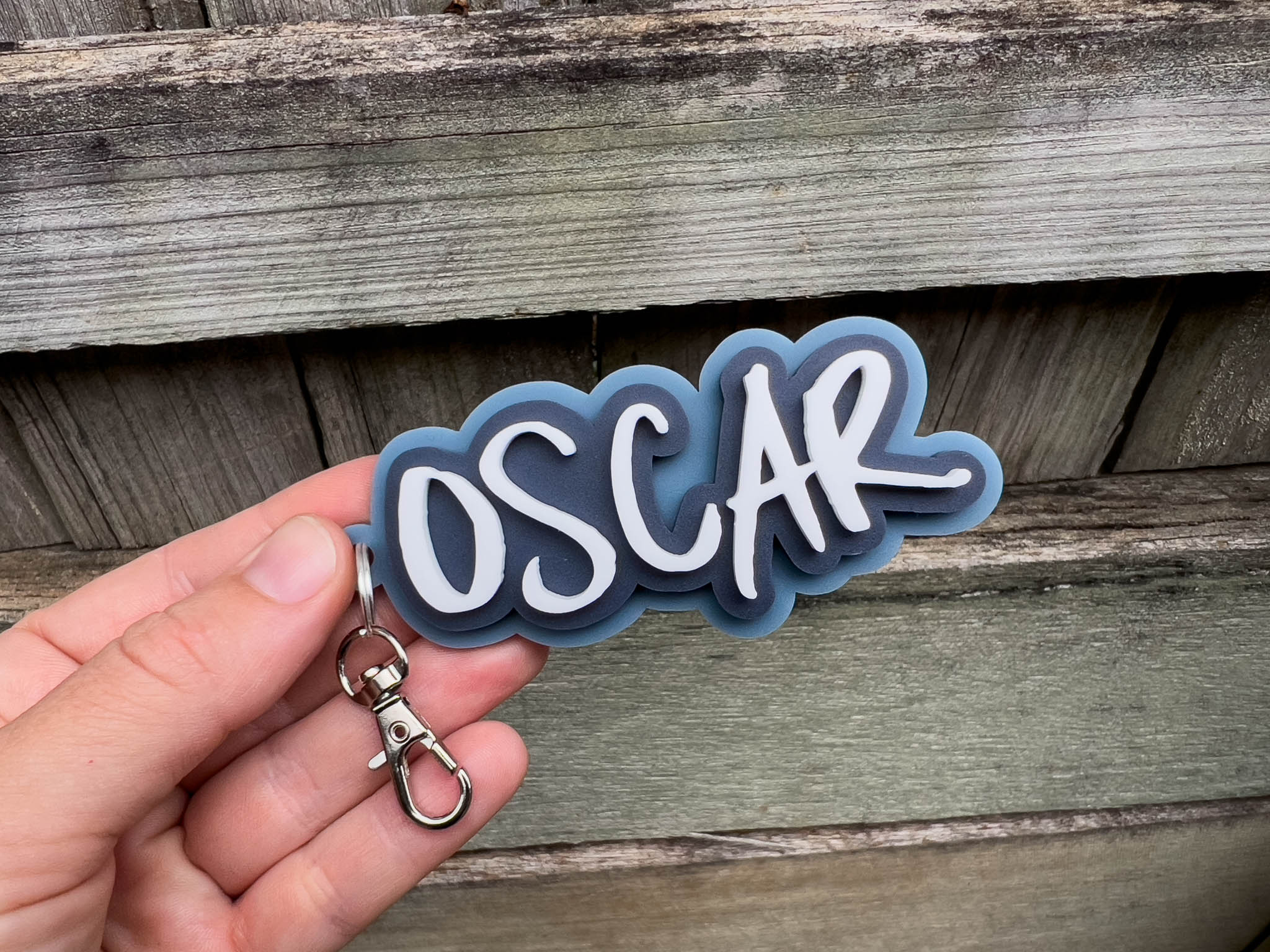Retro graffiti-style pesonalised acrylic keychain 'Oscar' in dusty blue, dark blue and white.