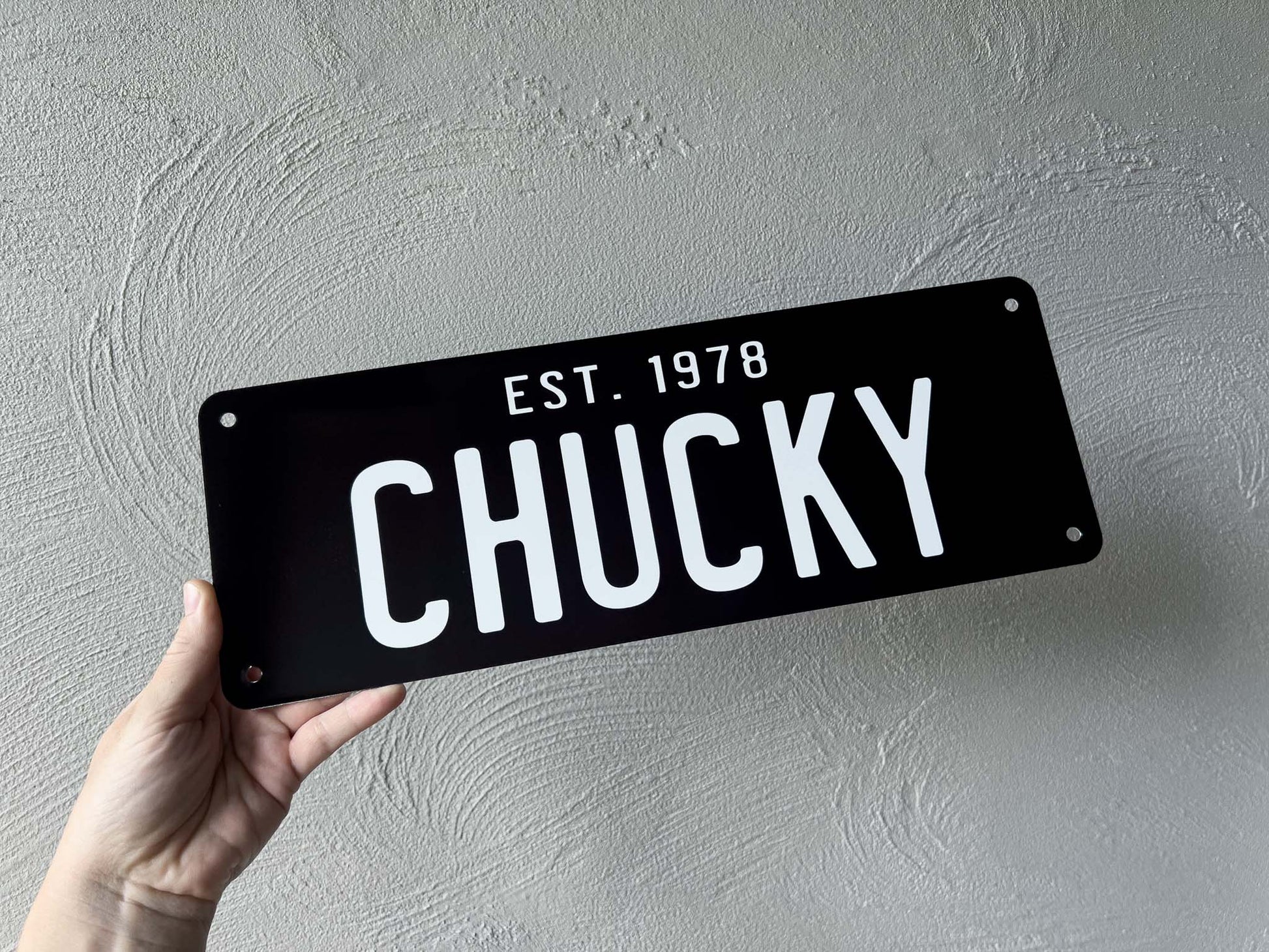 Custom printed black and white novelty number plate sign that says 'Chucky'