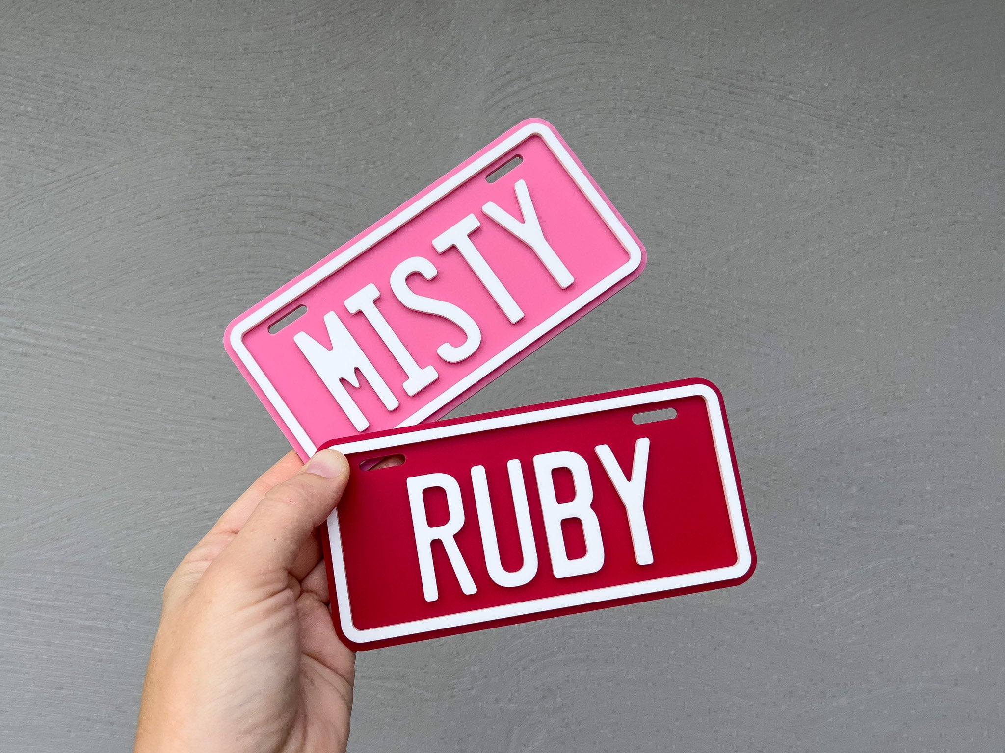 Two custom 3D acrylic mini plates with 'Misty' in pink and white and 'Ruby' in red and white | Coji Designs