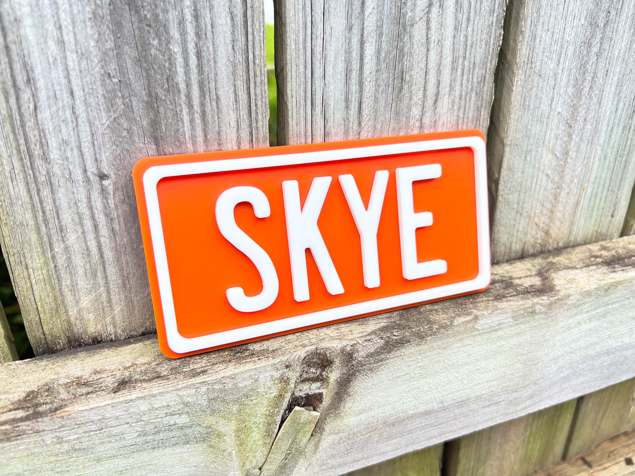 Personalised 3D mini acrylic sign with 'Skye' in a bright orange colour with white text.