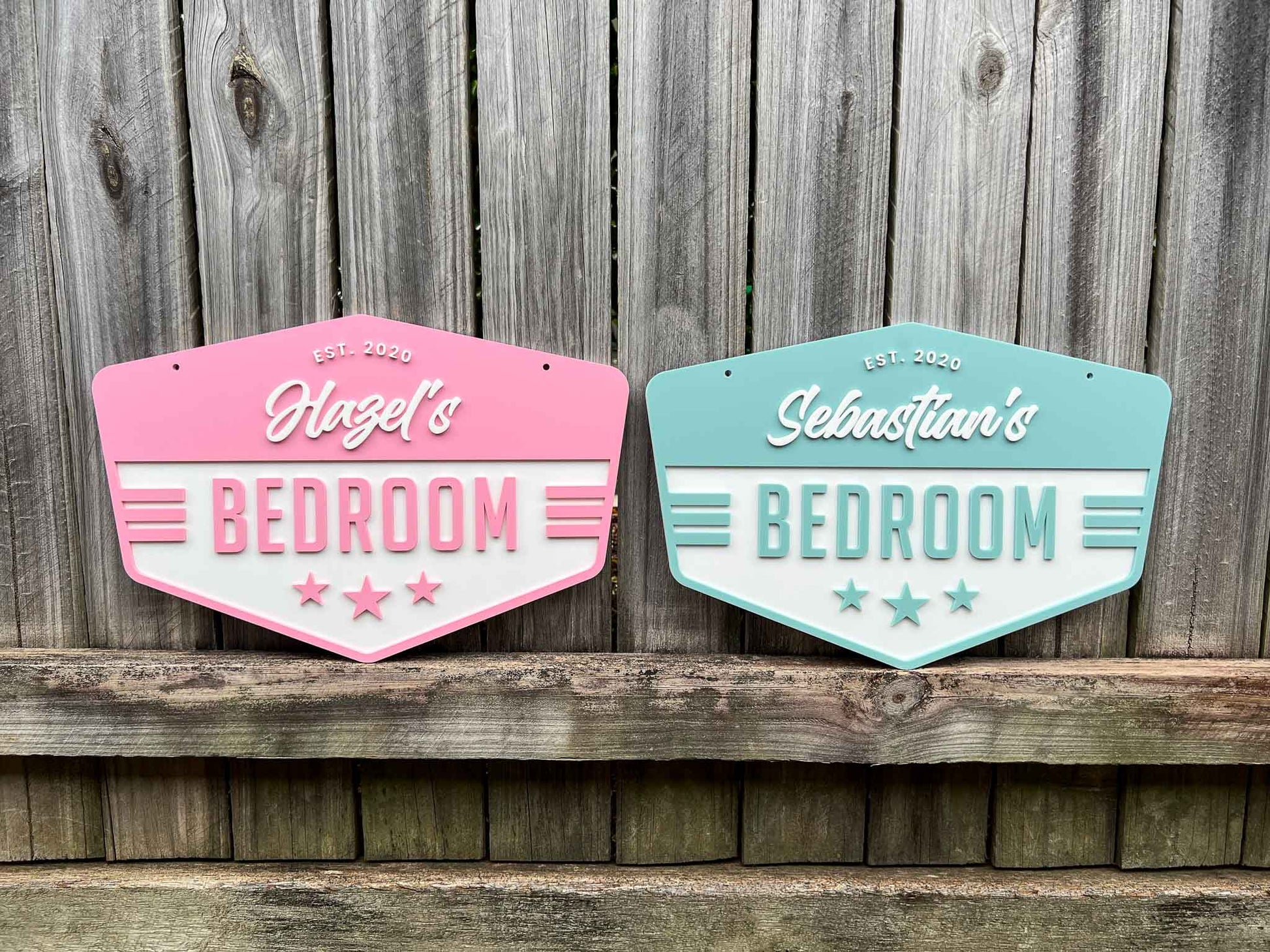 Two decorative bedroom signs for Hazel and Sebastian against a wooden background