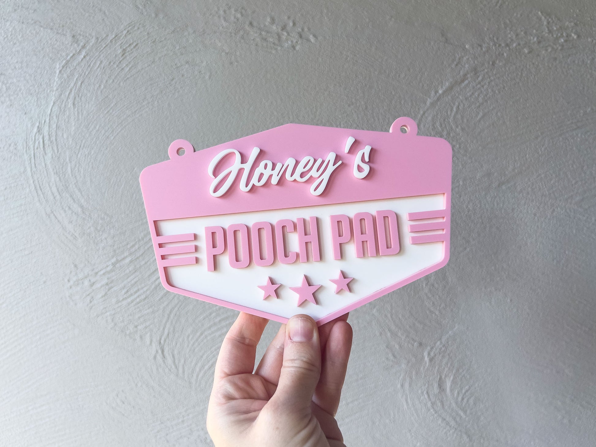 Pink sign with 'Honey's Pooch Pad' text held against a grey background | Coji Designs