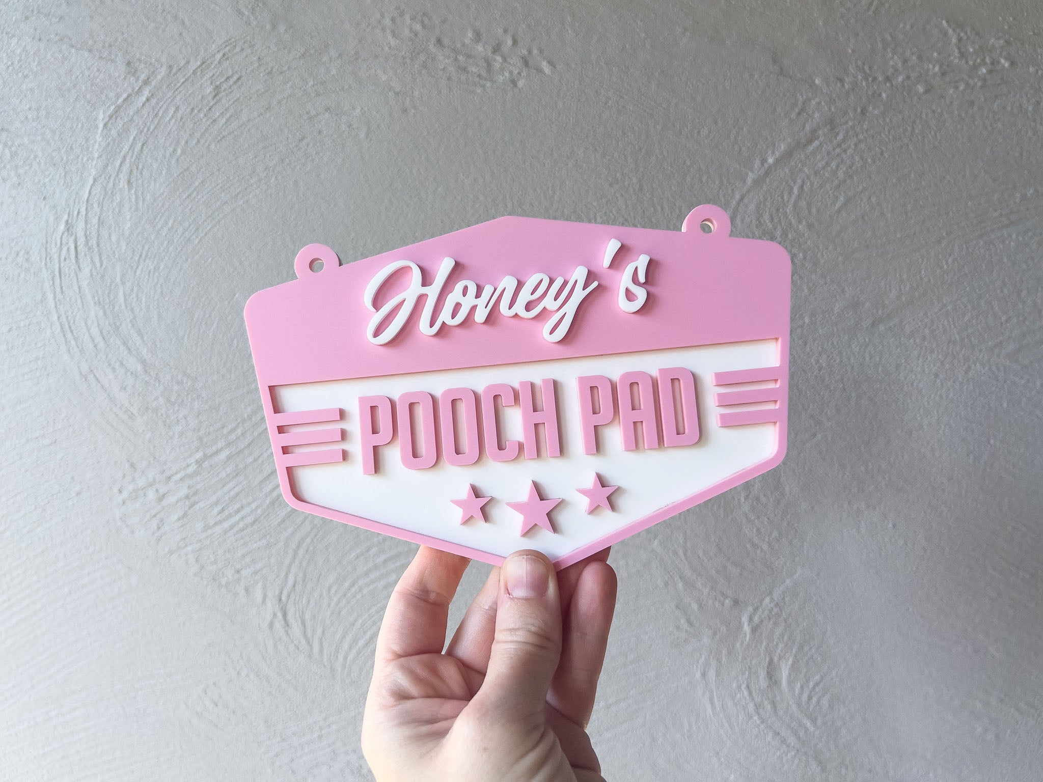 Pink sign with 'Honey's Pooch Pad' text held against a grey background | Coji Designs