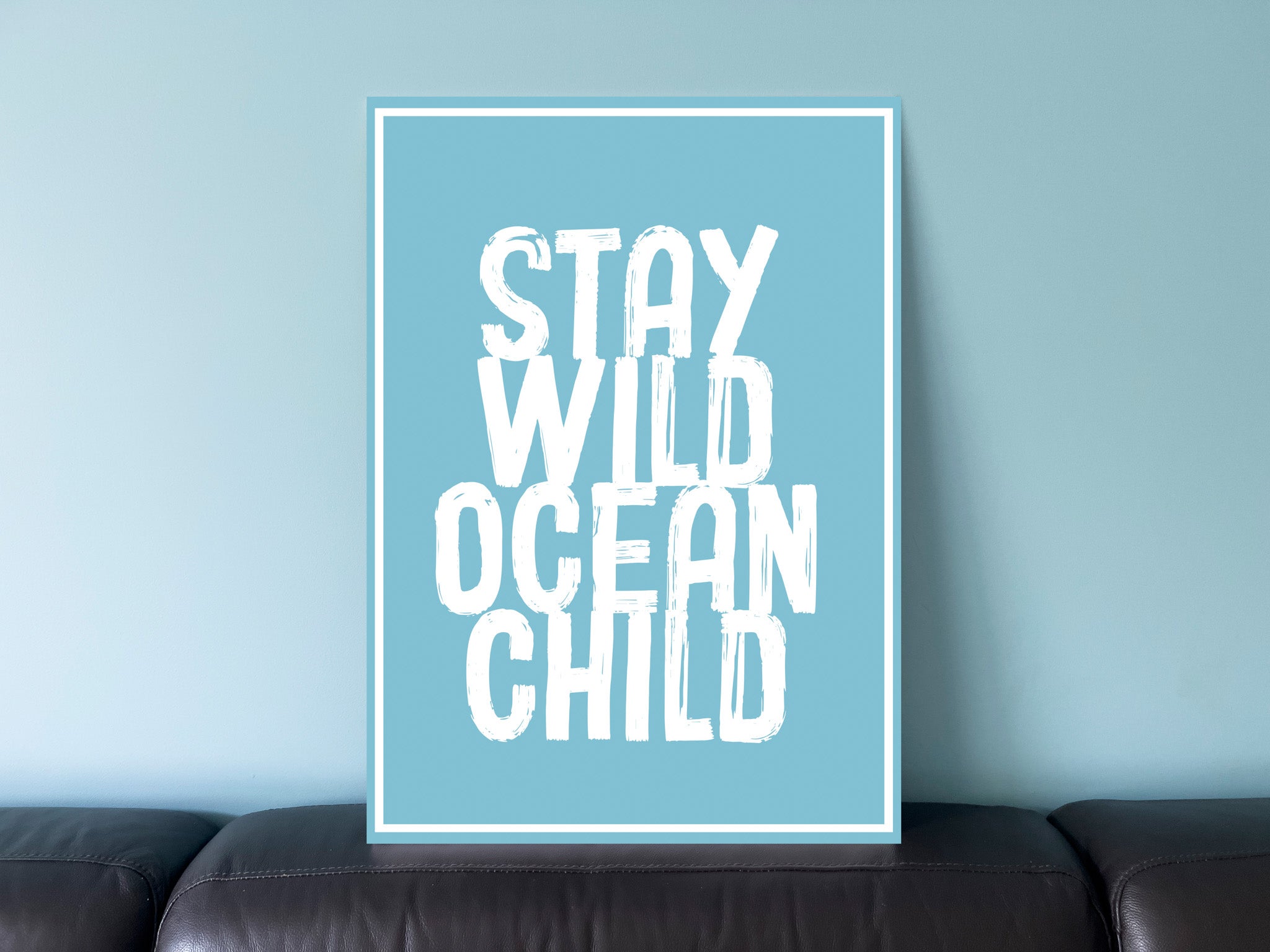 Ocean blue UV printed acrylic sign with 'Stay Wild Ocean Child' printed on it in white ink