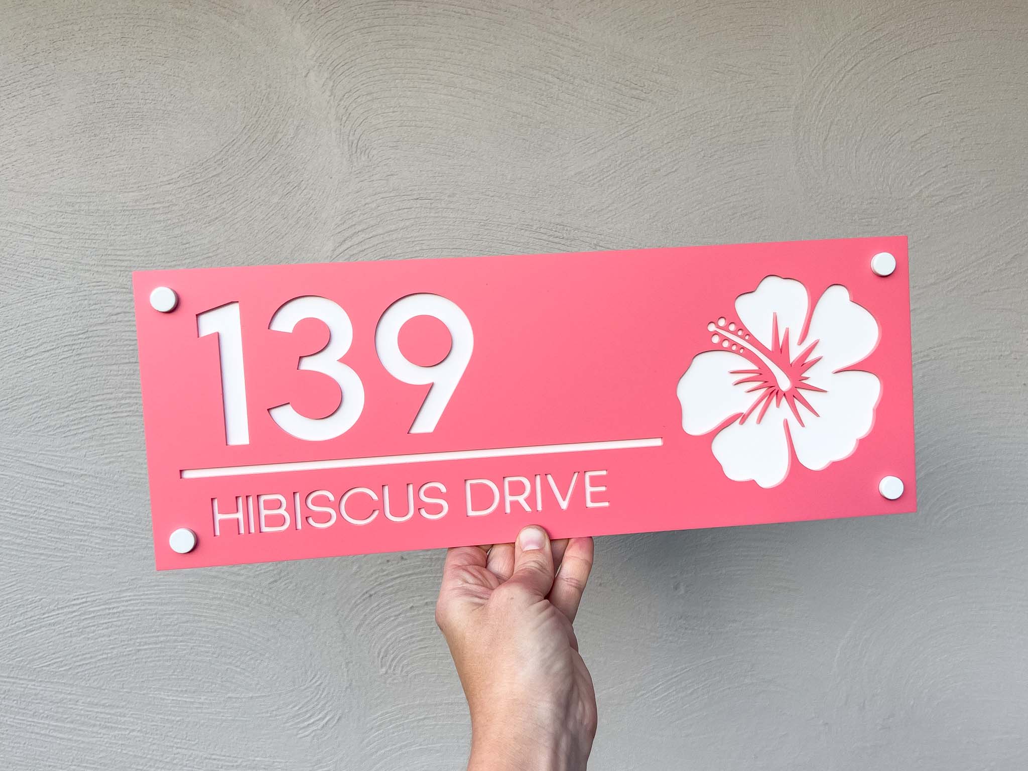 Stunning melon pink and white custom acrylic house sign with a hibiscus flower that says '139 HIBISCUS DRIVE'.
