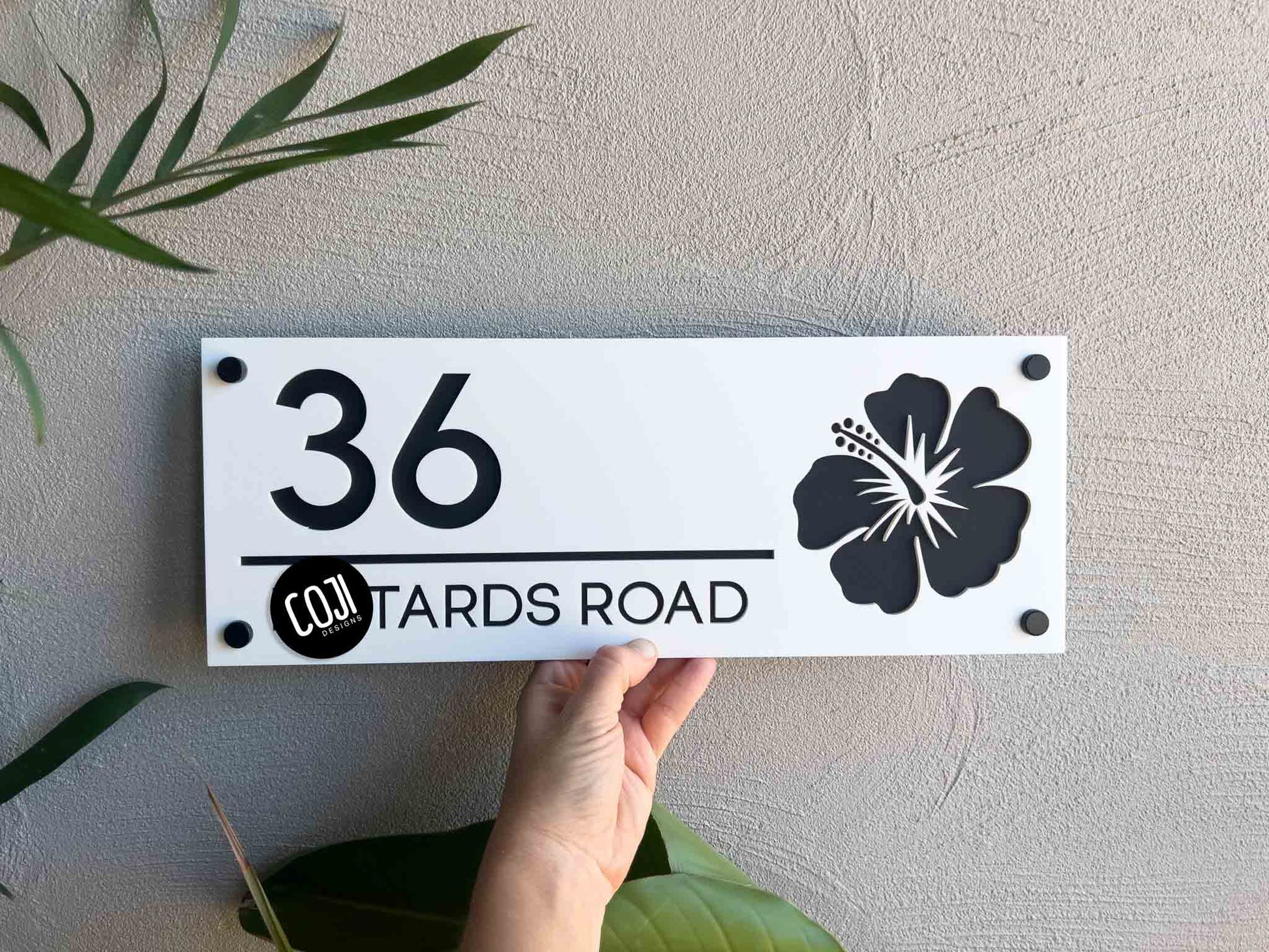 Personalised 3D acrylic hibiscus flower street address sign that reads '36 Road' in white and black.