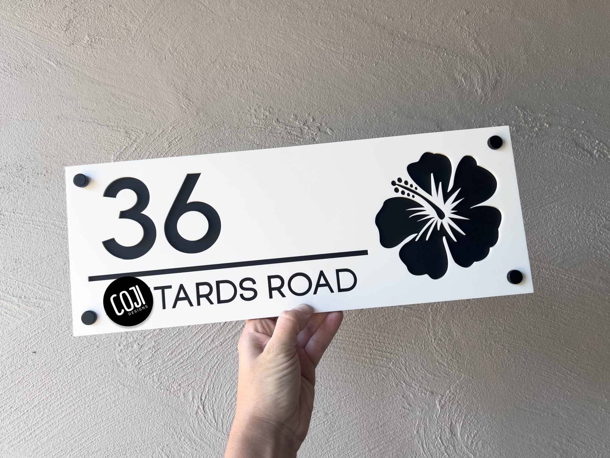 Custom made white and black hibiscus floral design house sign with the number '36'.
