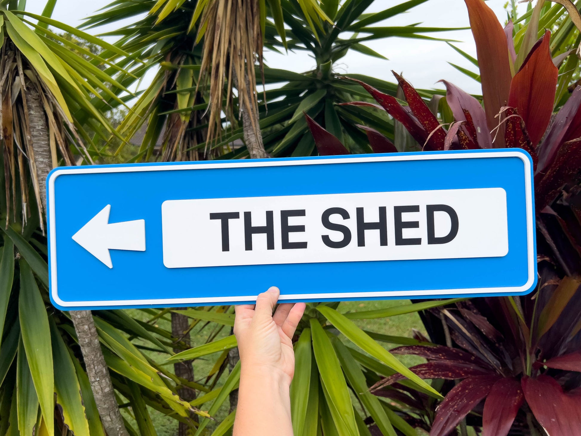 Custom made 3D acrylic outdoor street style sign that says 'THE SHED' in blue and white.