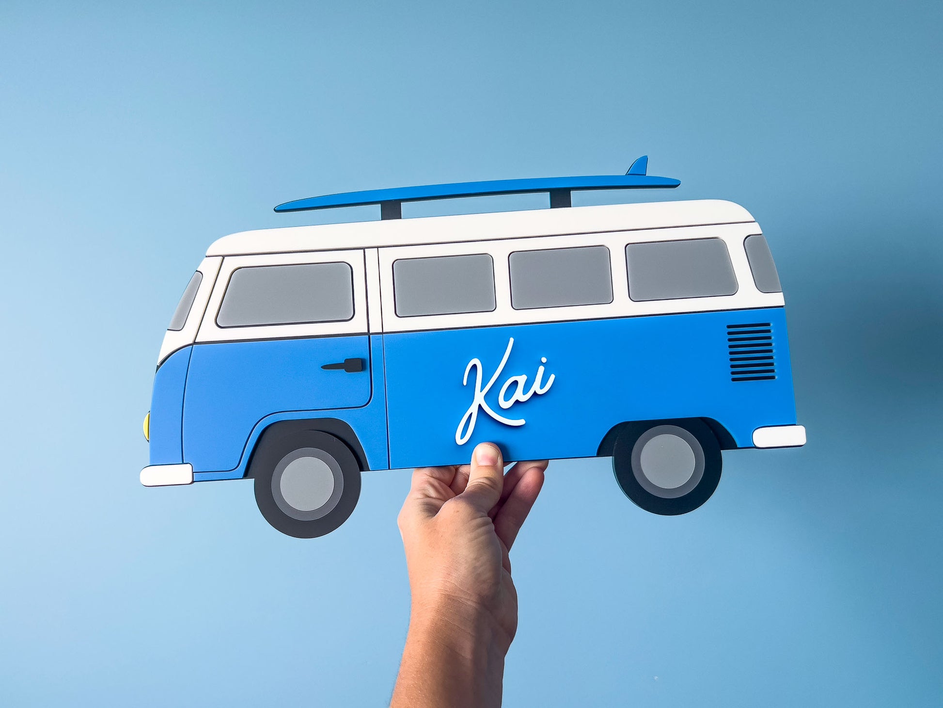 Blue and white custom made acrylic surf van with 'Kai' on a blue background