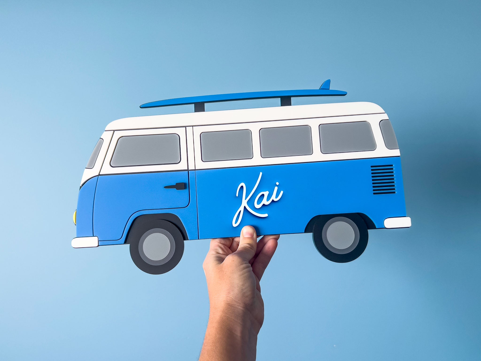 Blue and white custom made acrylic surf van with 'Kai' on a blue background