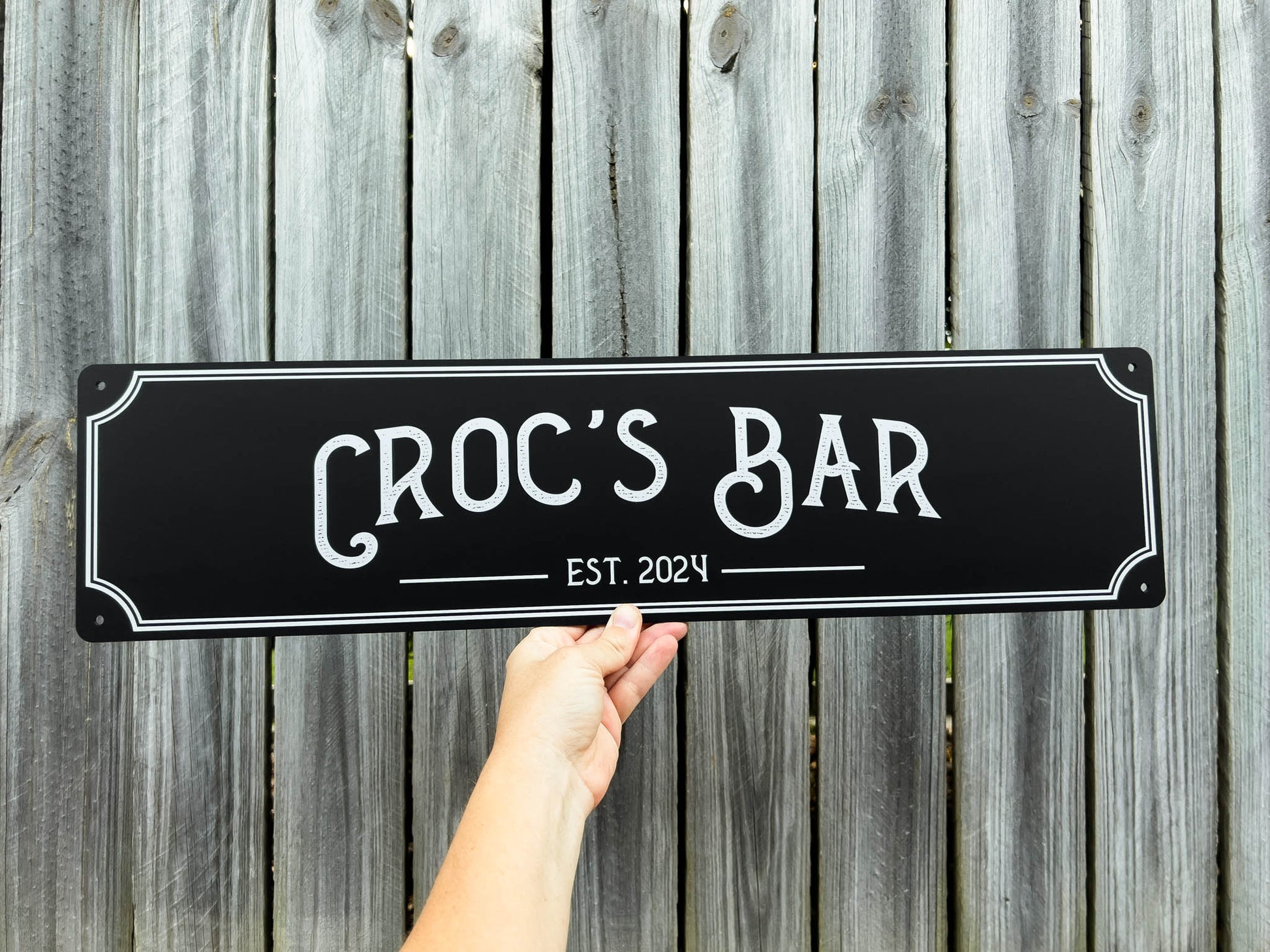 Custom UV printed bar sign panel in black and white tthat reads 'Croc's Bar Est. 2024'.