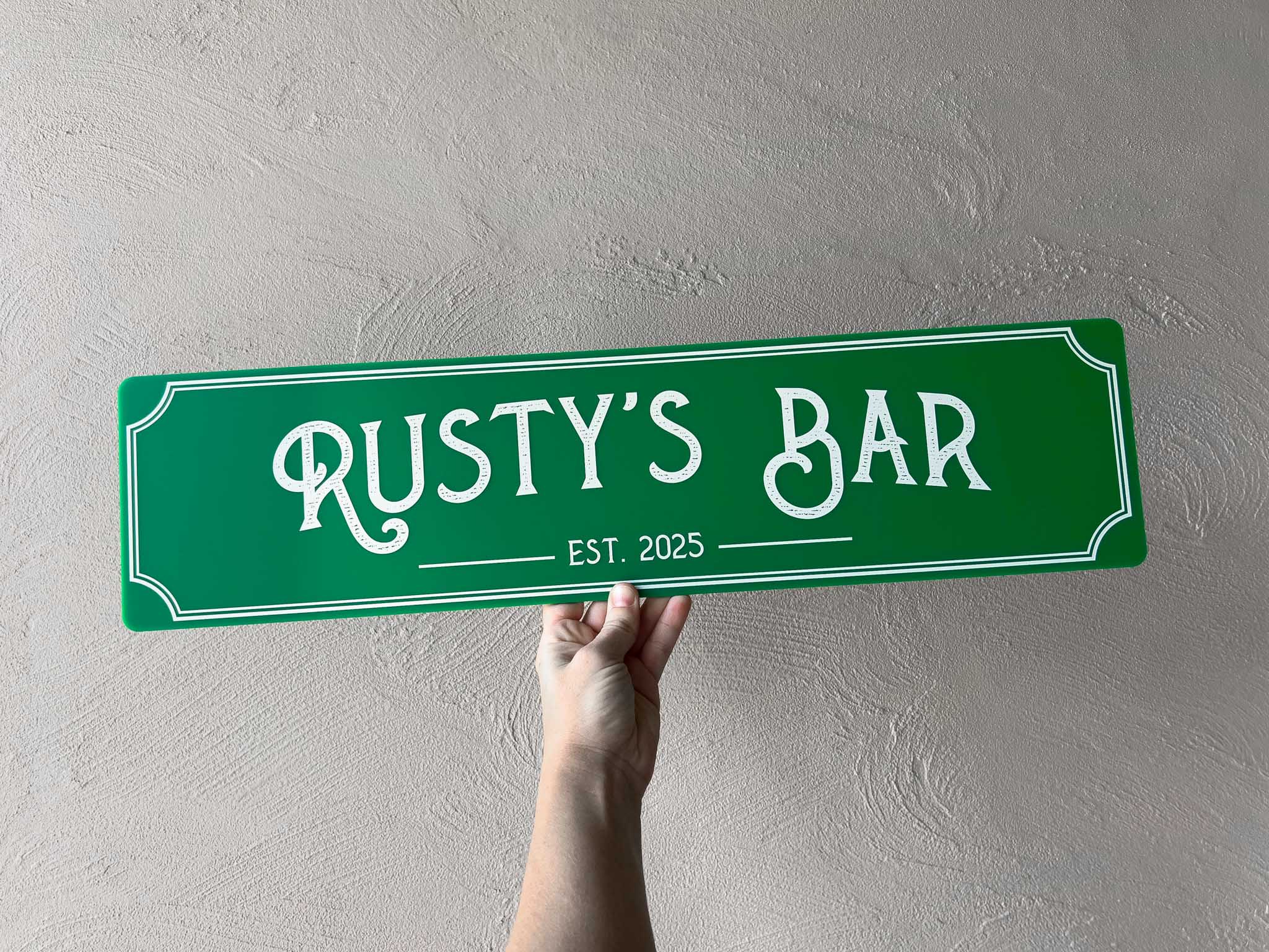 Personalised palm green panel with text white UV ink that says 'Rustys Bar' in a vintage saloon style design
