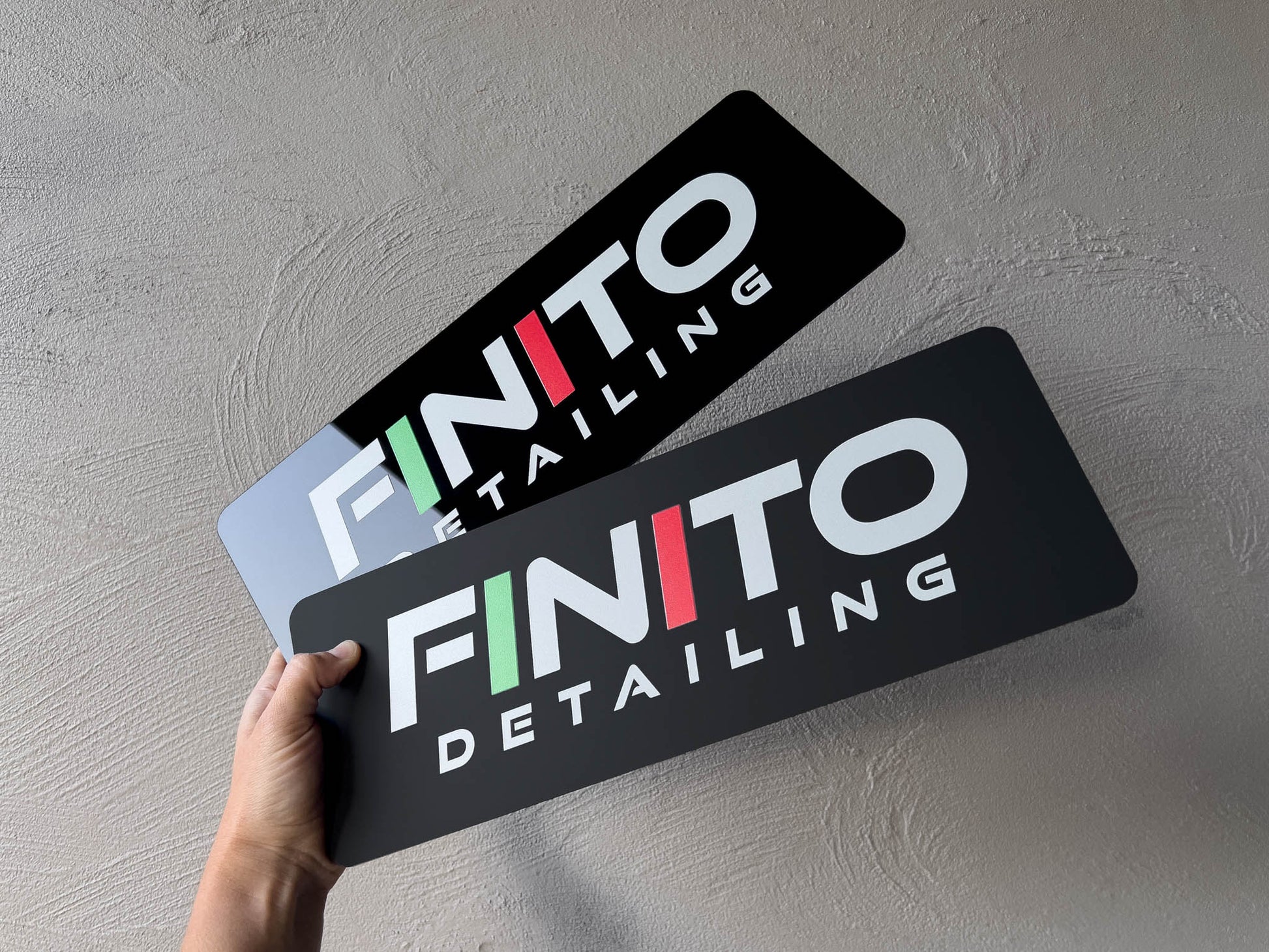 Custom printed logo plates in gloss and matte with the branding 'Finito' on them.
