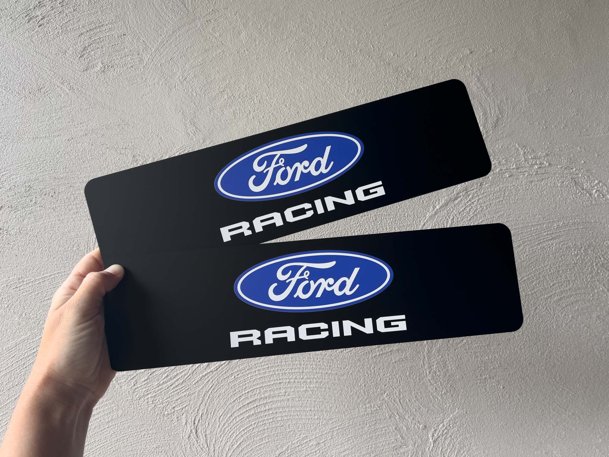 Two custom black acrylic logo plates with 'Ford Racing' Branding