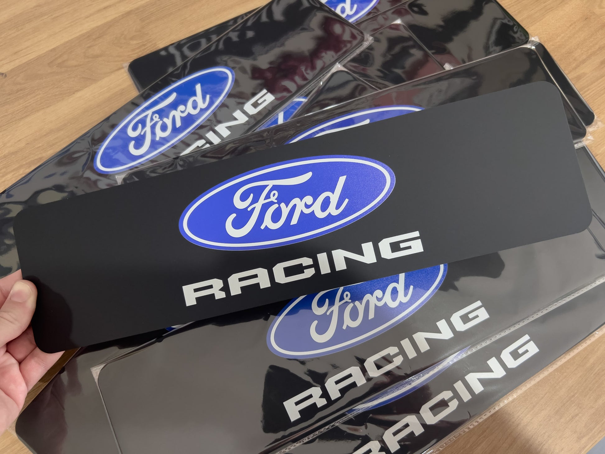 Collection of 'Ford Racing' custom UV printed logo plates on black acrylic.