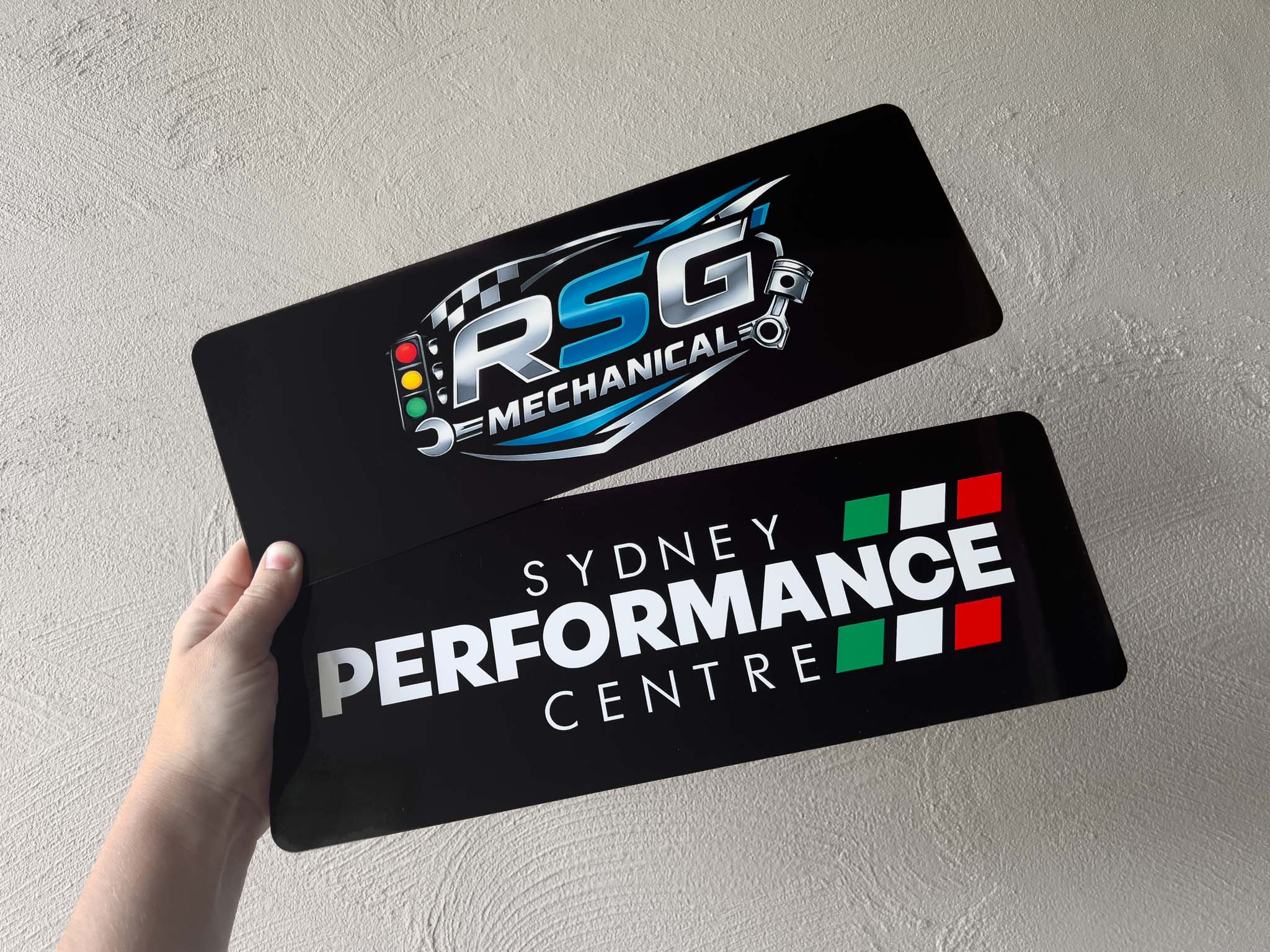 Two custom branded logo cover plates printed on aluminium plates