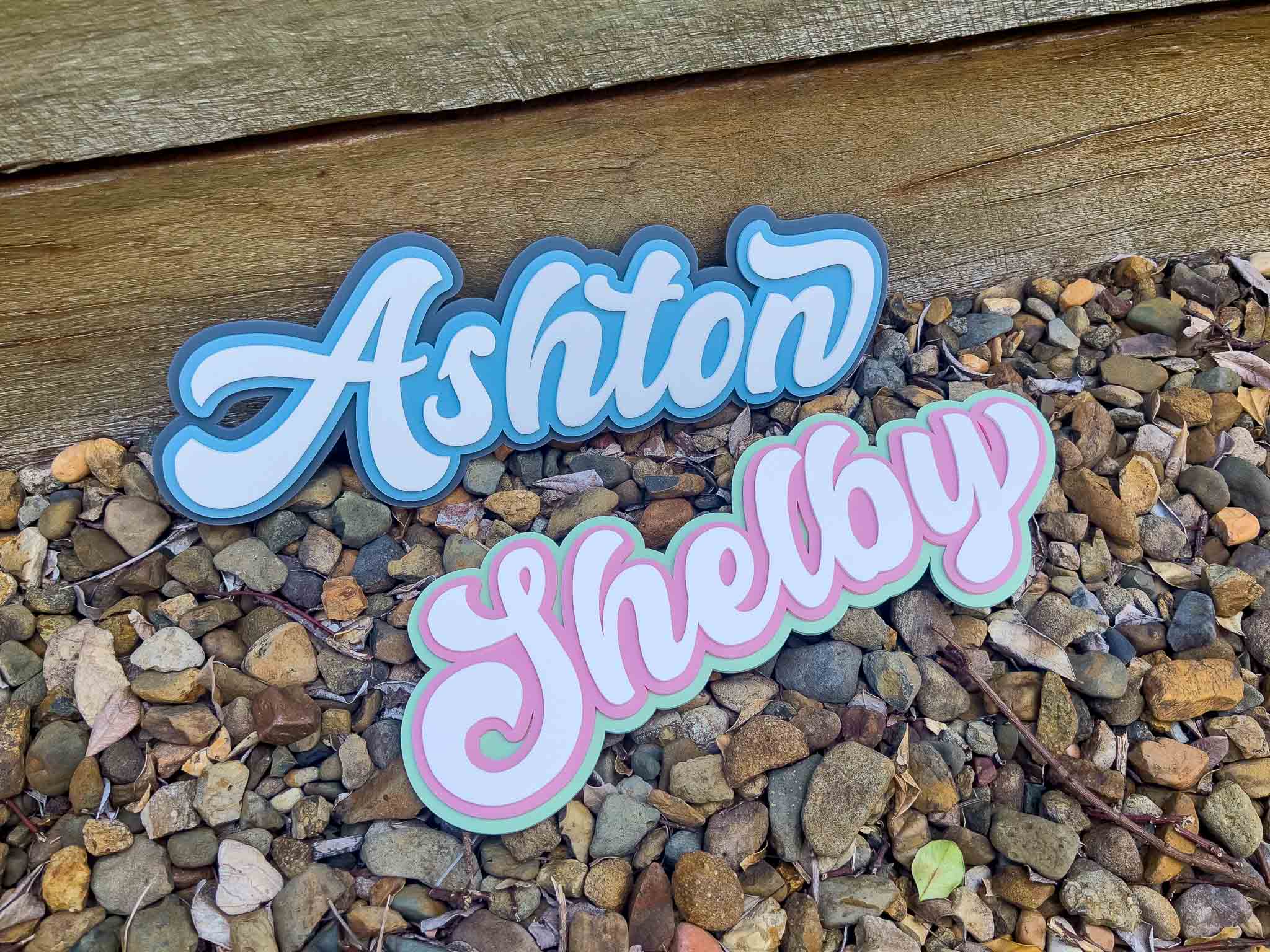 Nostalgic custom 3D name signs 'Ashton' & 'Shelby' in a bubble swirly typography.