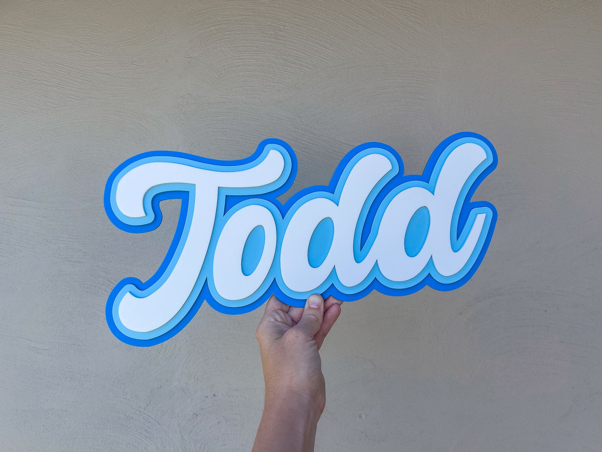 Surf blue tones personalised name plaque that reads 'Todd' for kid's bedroom.