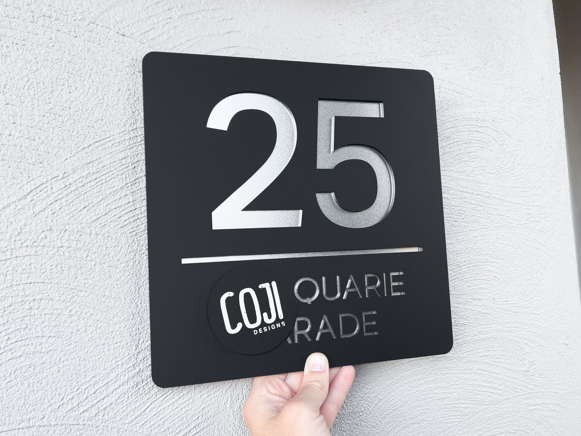 Elegant simple black and metallic silver Michagan street sign that reads the number '25' 