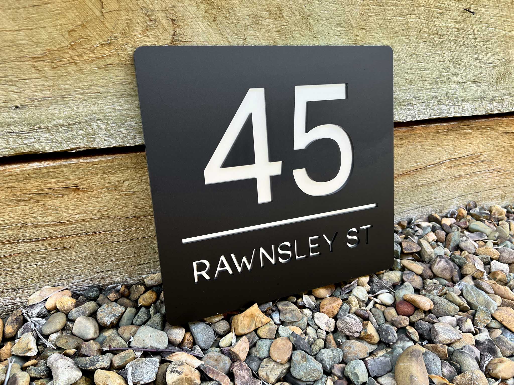 Classic 3D acrylic address sign that reads '45 Rawnsley St' in black and white.