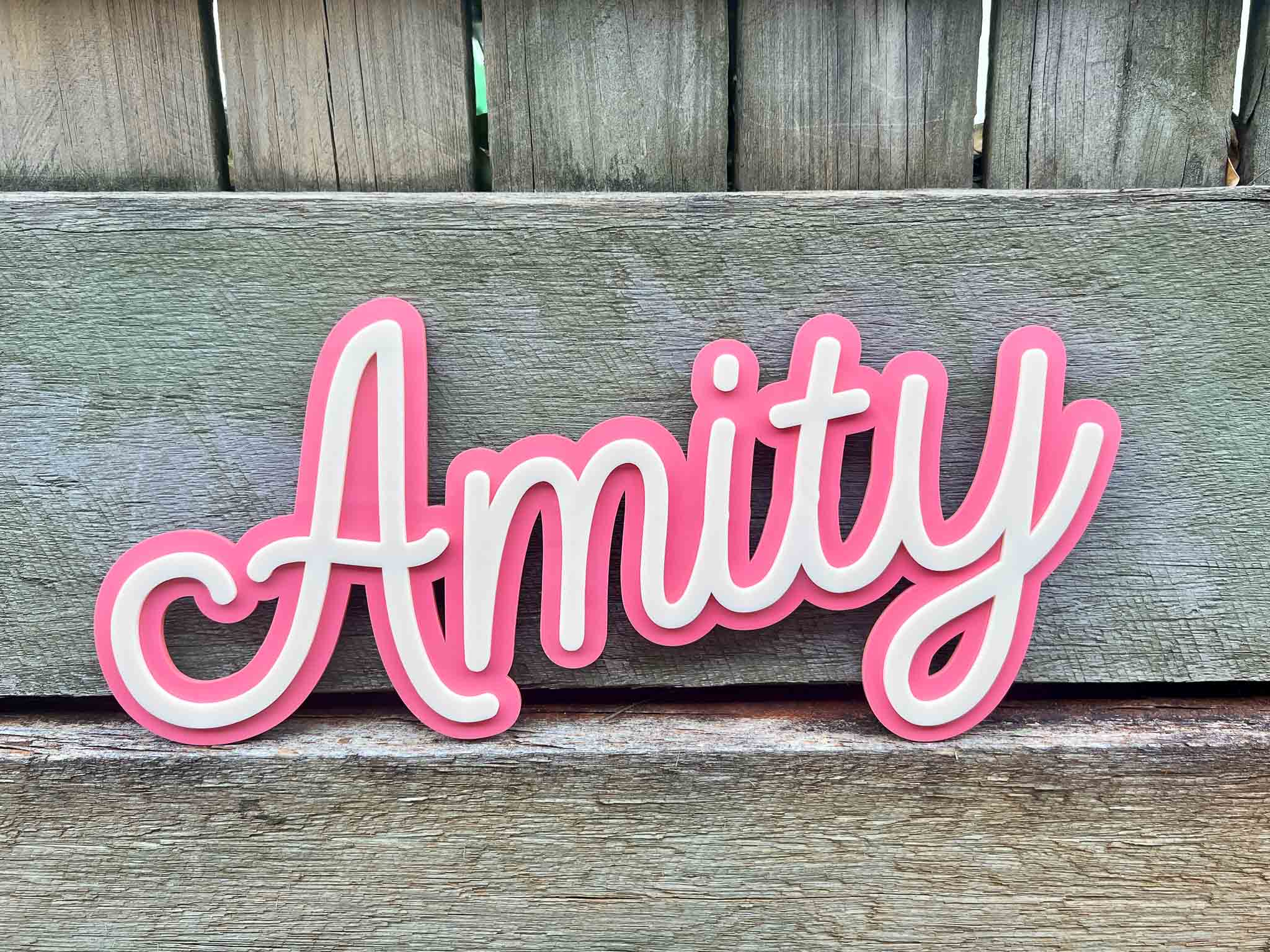 Classic ice cream sundae style 3D name plaque 'Amity' in coral pink and cream.