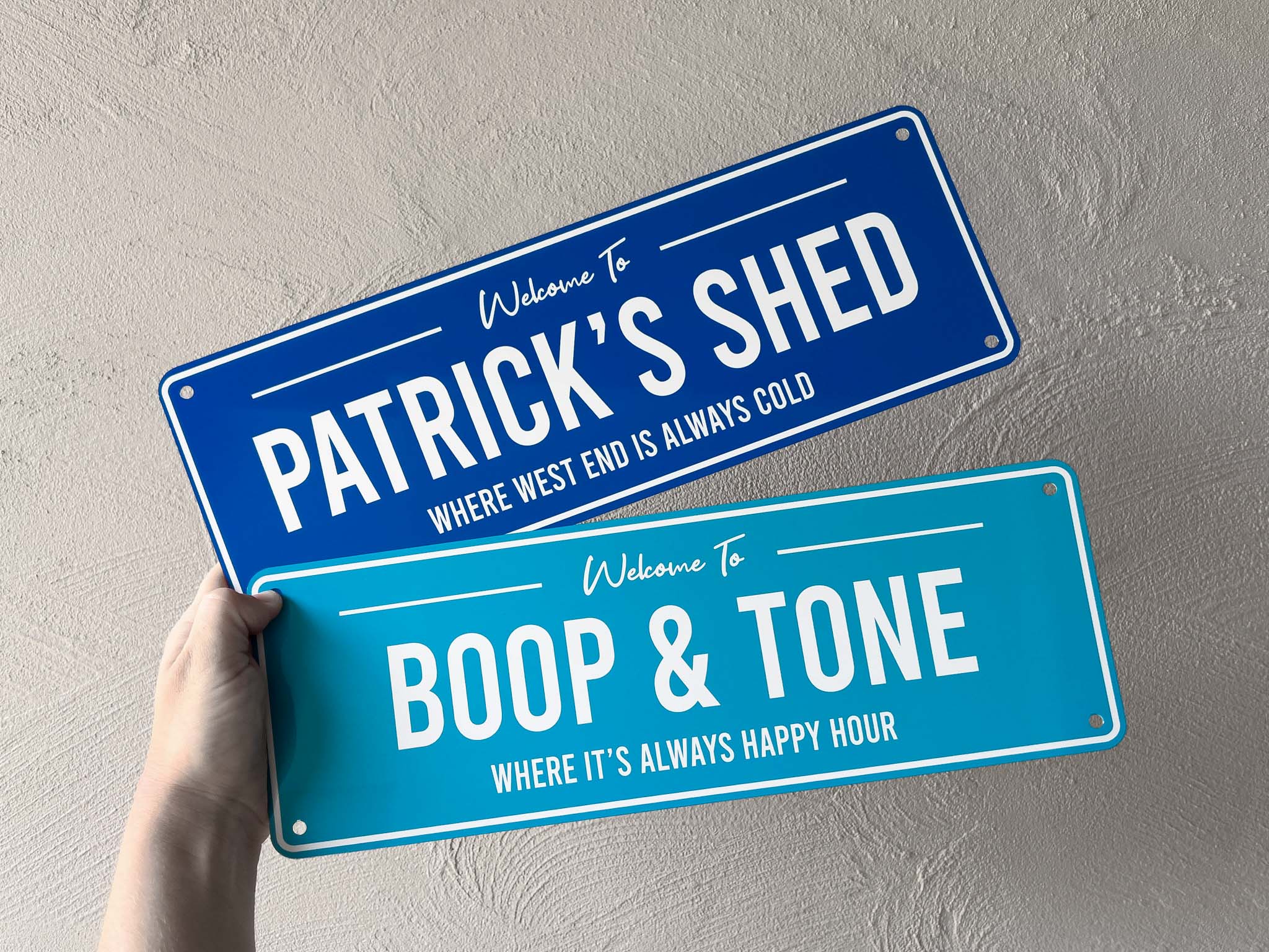 Two blue and white printed aluminium panels with mounting holes
