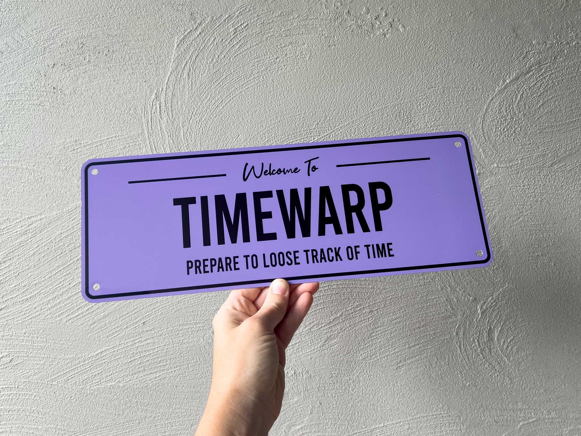Custom printed purple and black bar sign that reads 'Timewarp'.