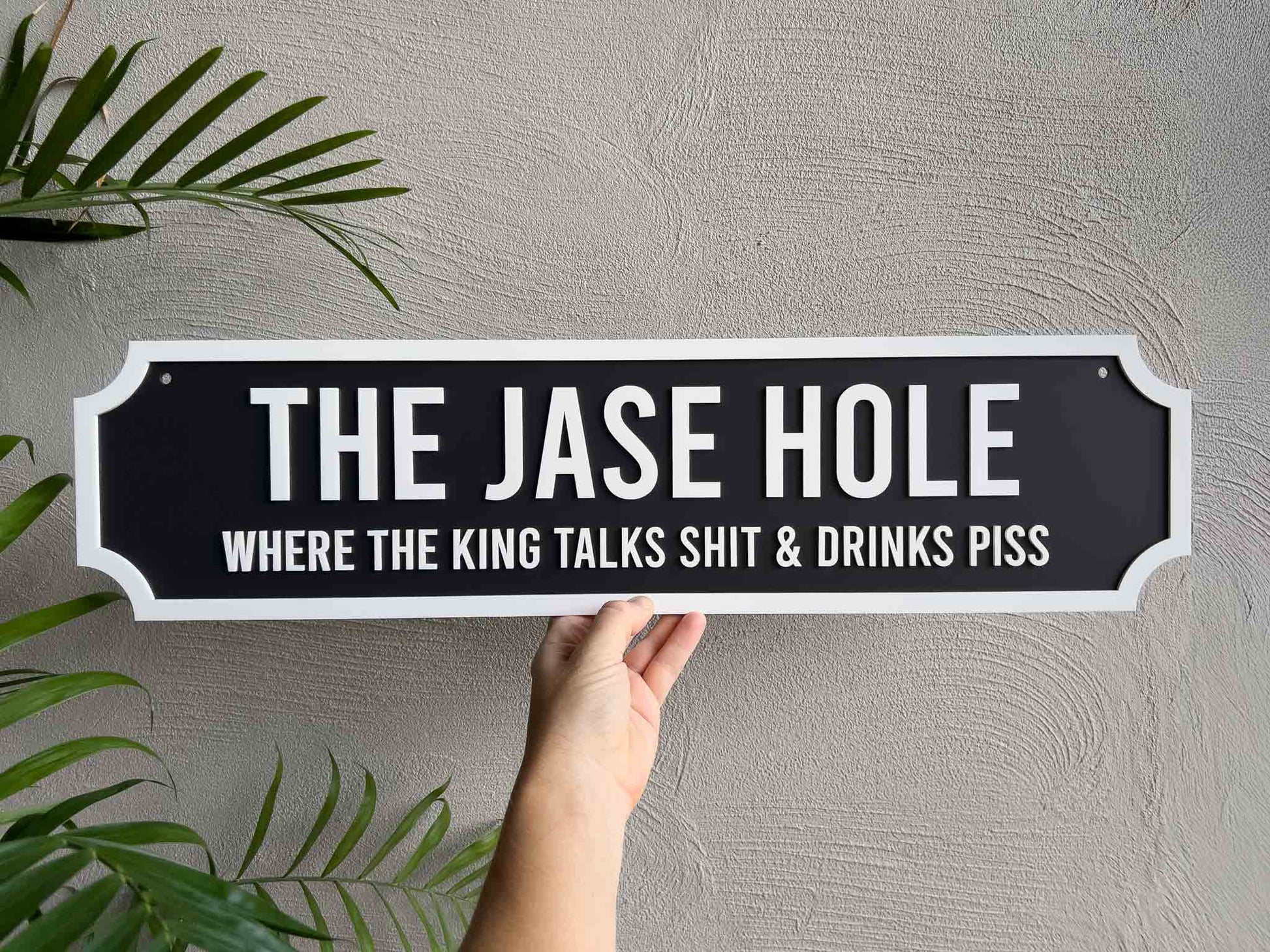 A classic black and white sign panel with humerous text.