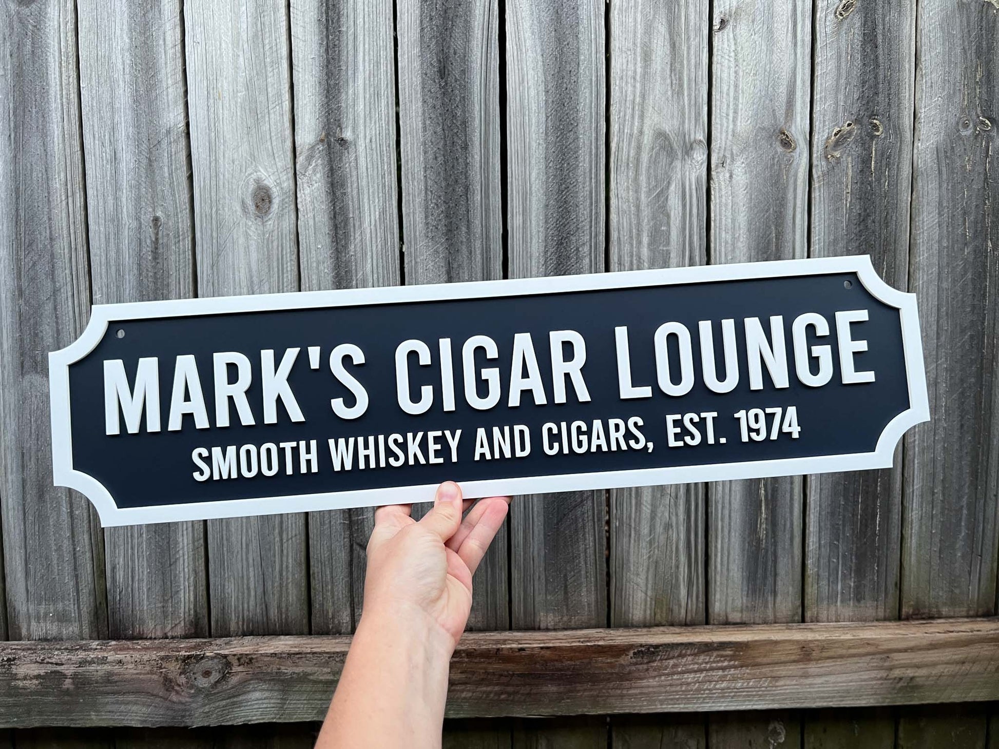 Traditional vintage 3D acrylic sign that reads 'Mark's Cigar Lounge' against a wooden background