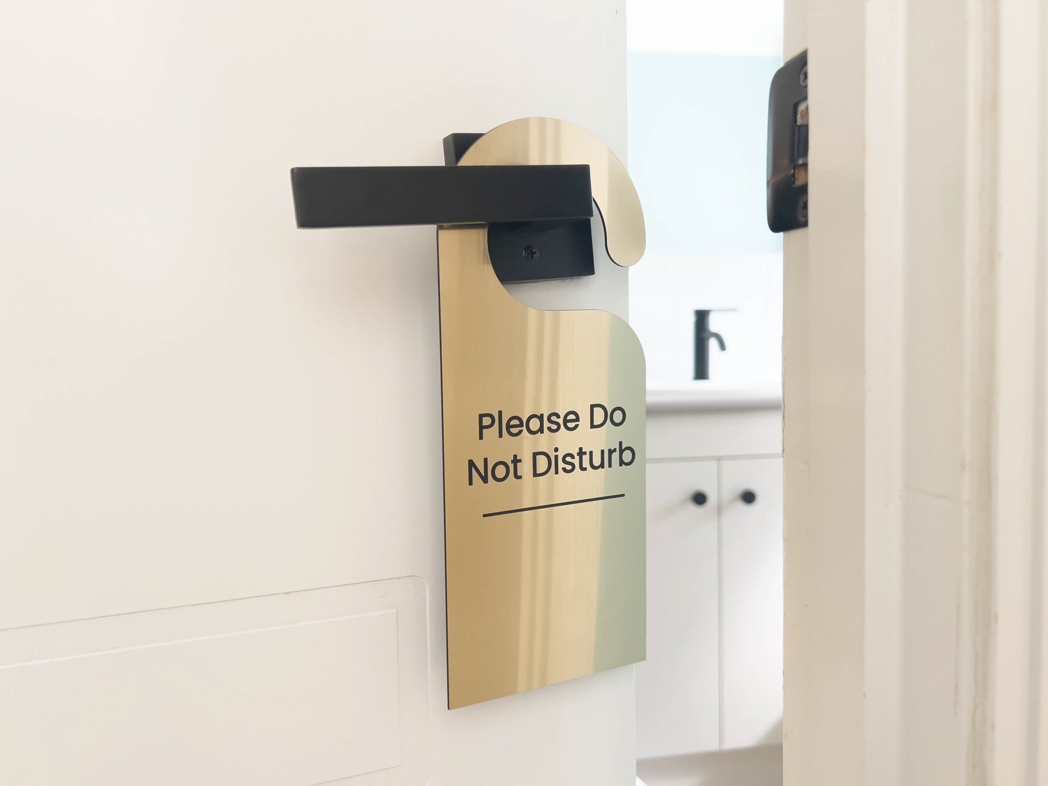Brushed gold custom engraved acrylic door hanger that reads 'Please Do Not Disturb' for beauty clinic.
